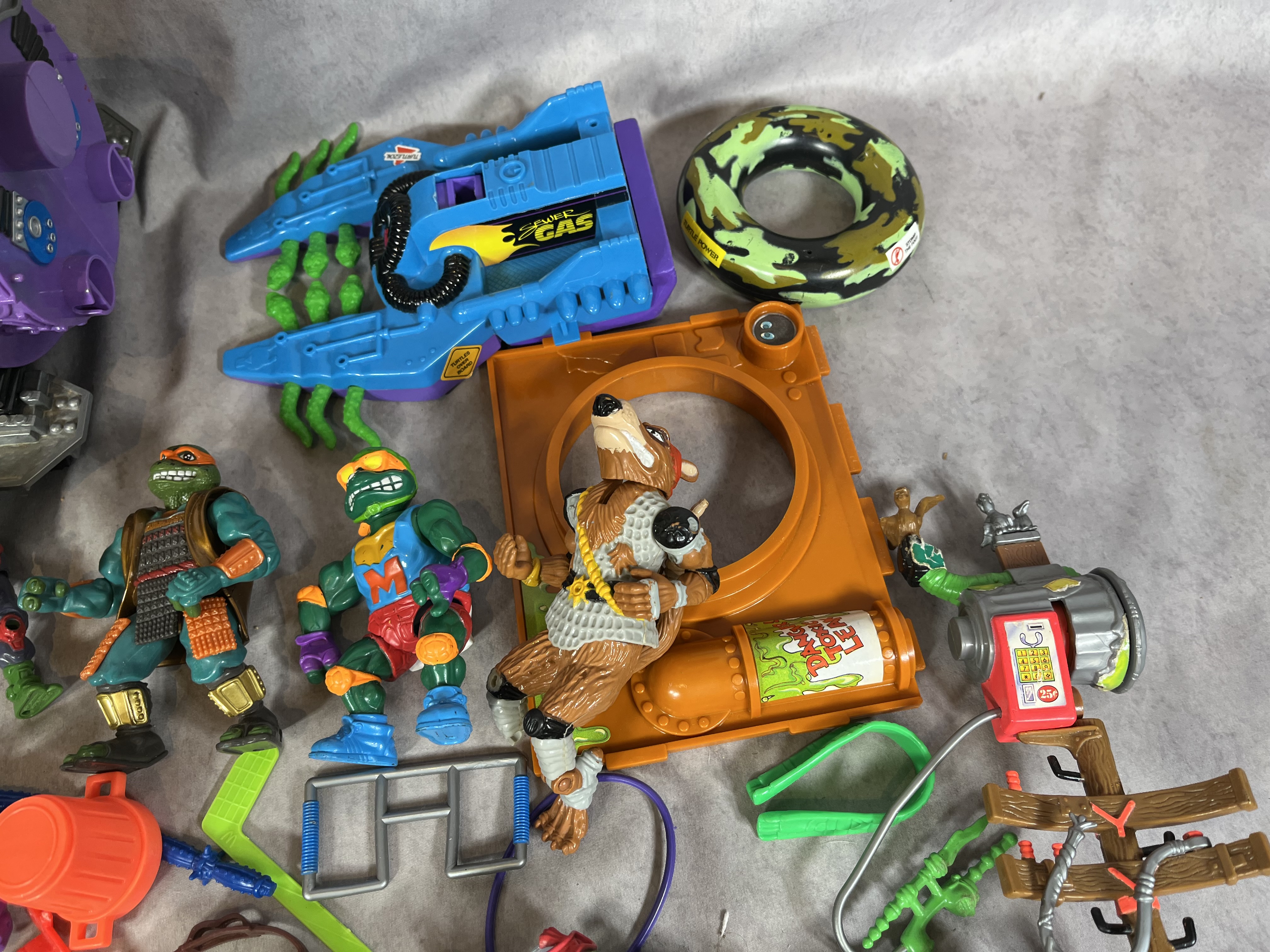 A Collection of Vintage Teenage Mutant Ninja Turtles Action Figures and Vehicles by Playmates