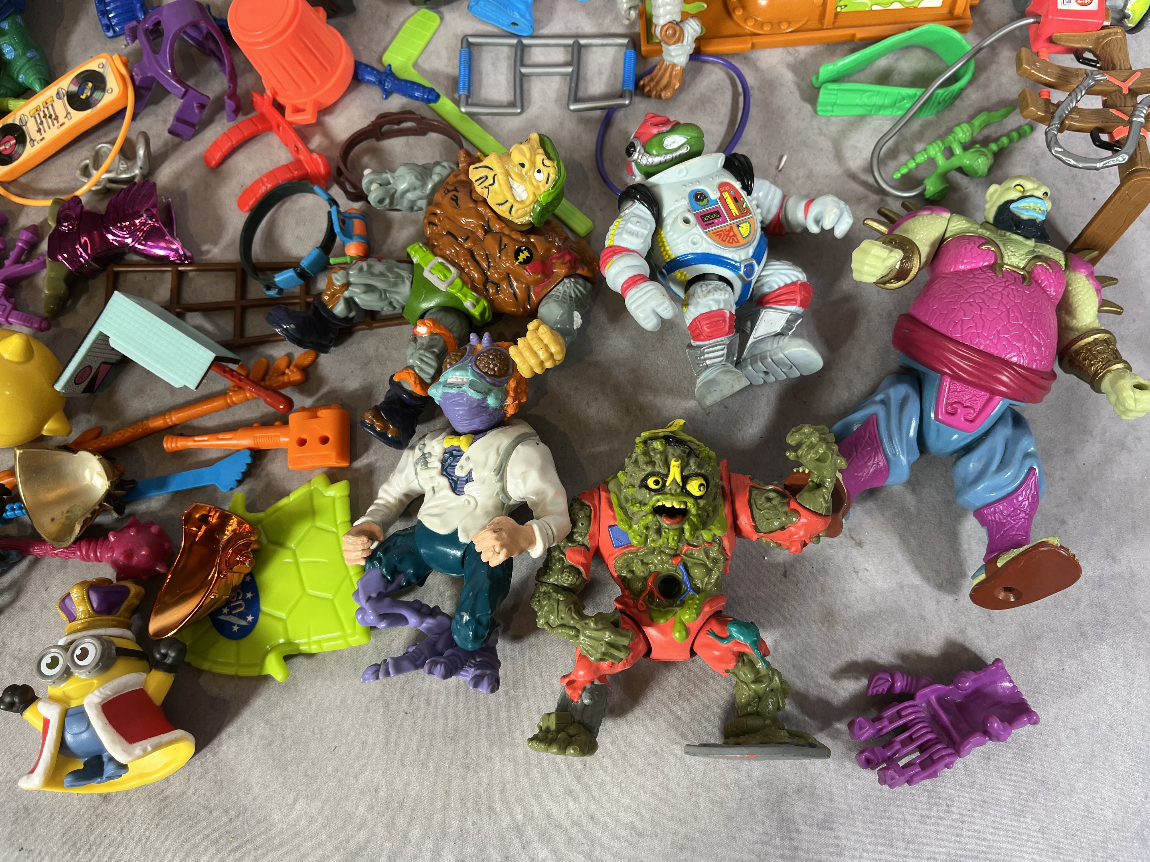 A Collection of Vintage Teenage Mutant Ninja Turtles Action Figures and Vehicles by Playmates