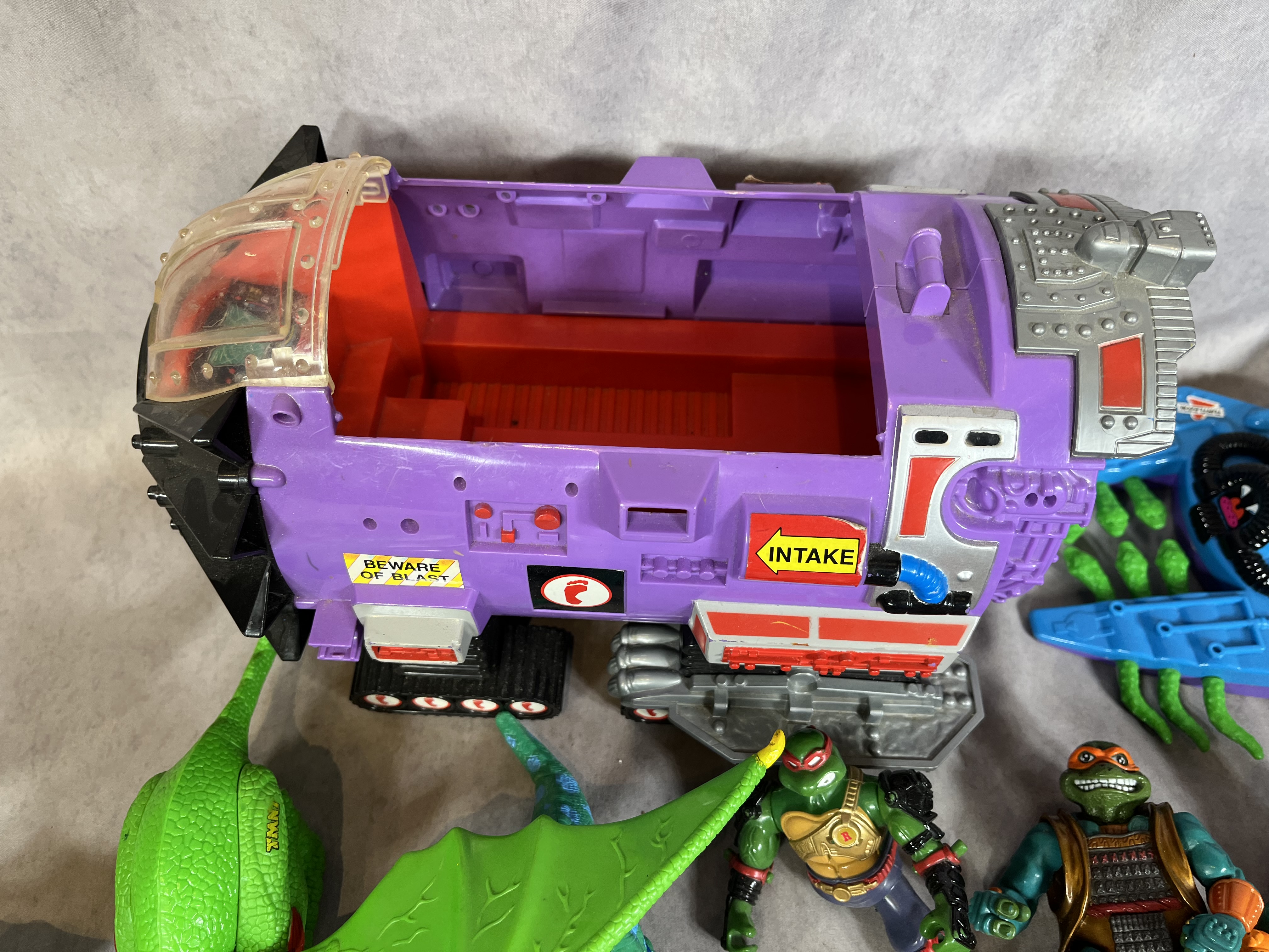 A Collection of Vintage Teenage Mutant Ninja Turtles Action Figures and Vehicles by Playmates