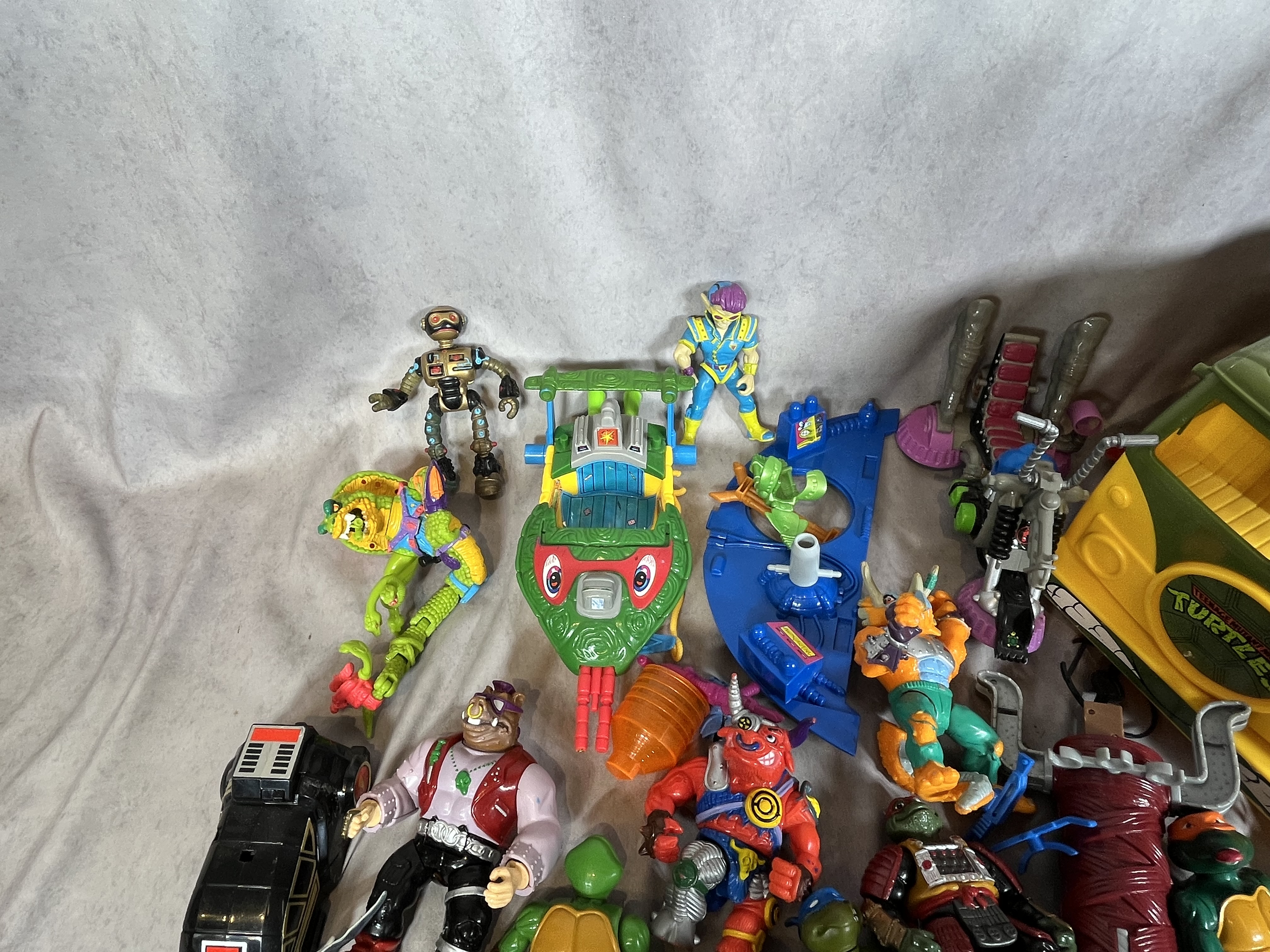 A Collection of Vintage Playmates Teenage Mutant Ninja Turtles Action Figures and Vehicles