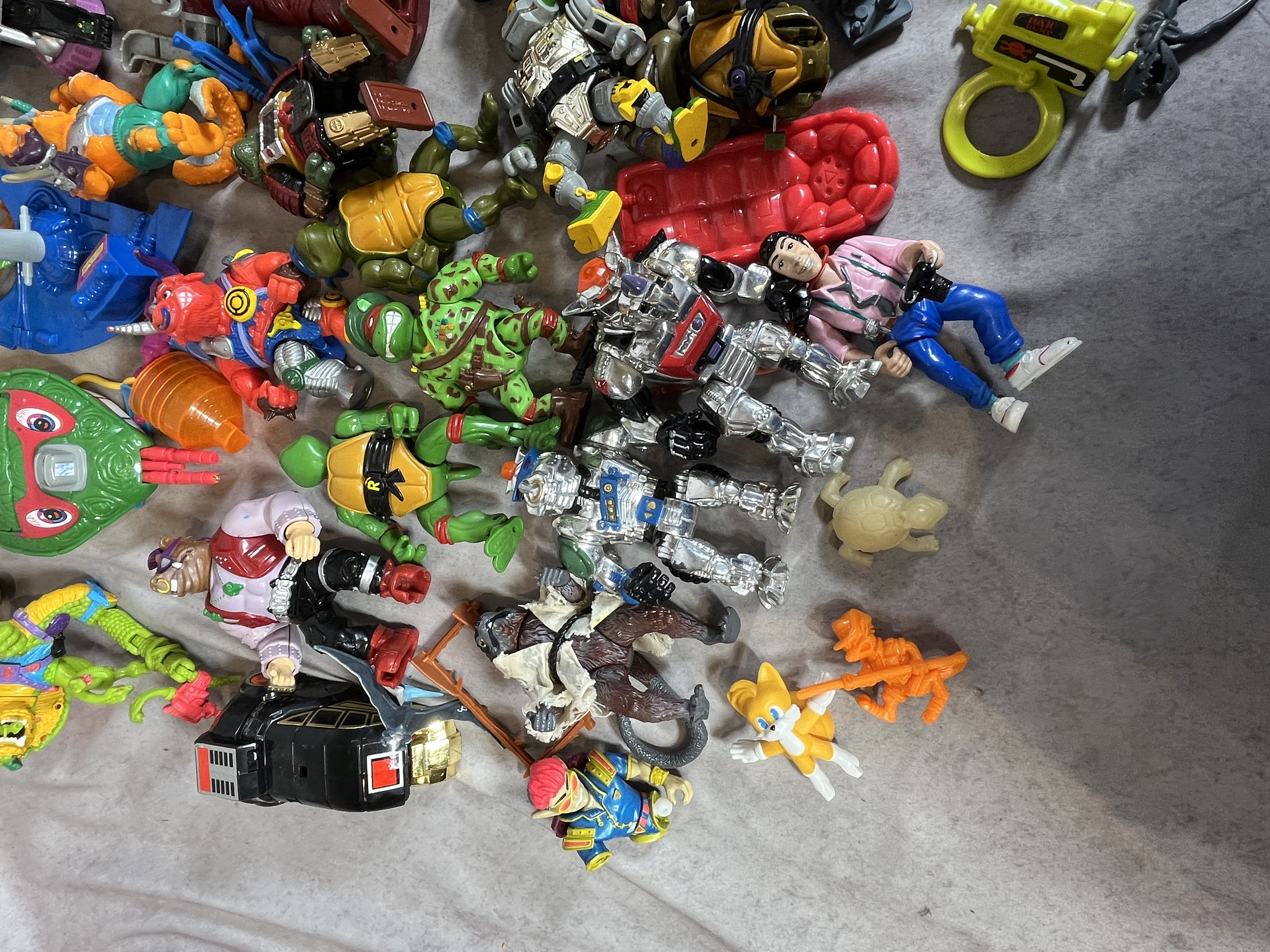 A Collection of Vintage Playmates Teenage Mutant Ninja Turtles Action Figures and Vehicles