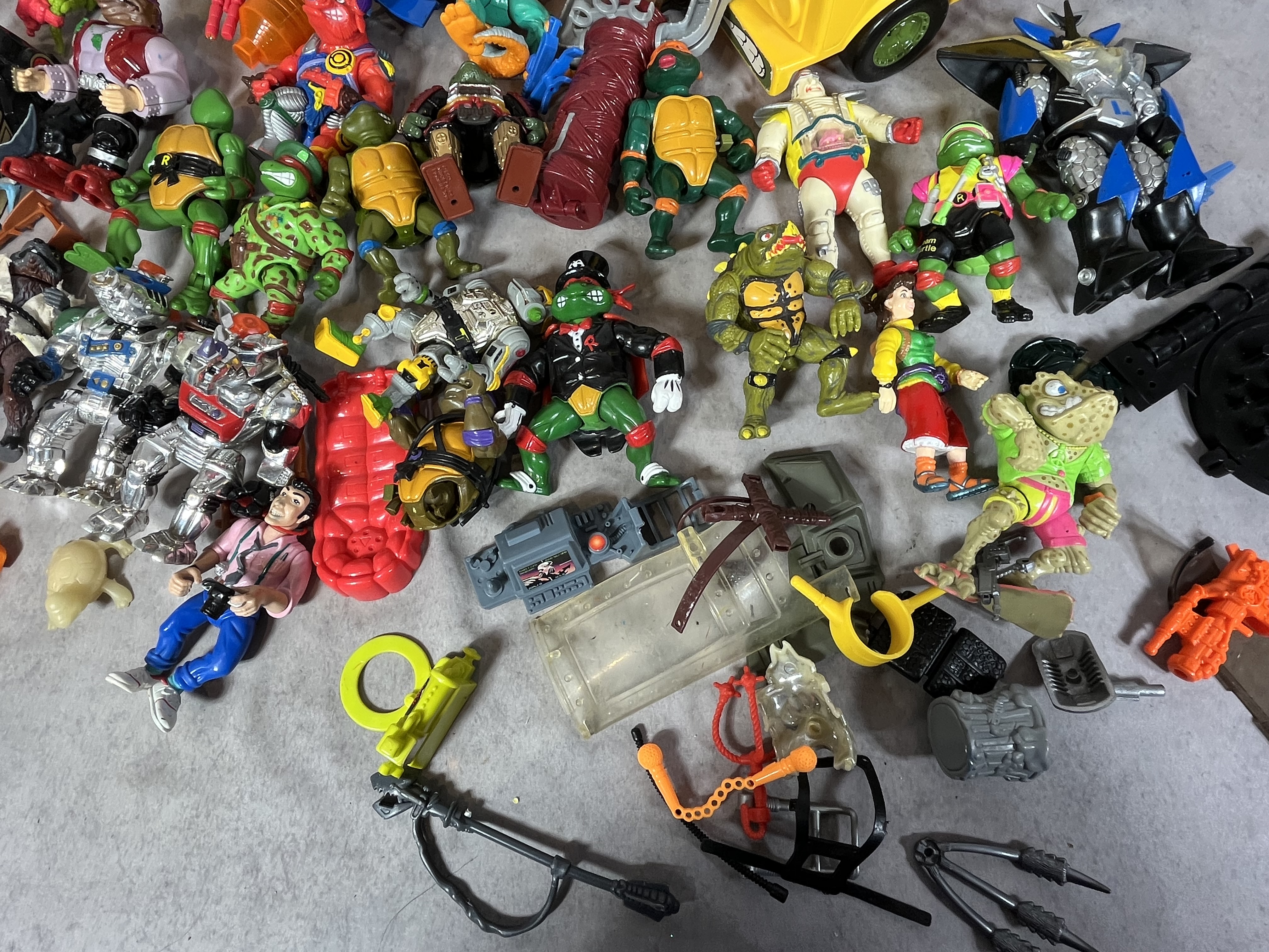 A Collection of Vintage Playmates Teenage Mutant Ninja Turtles Action Figures and Vehicles