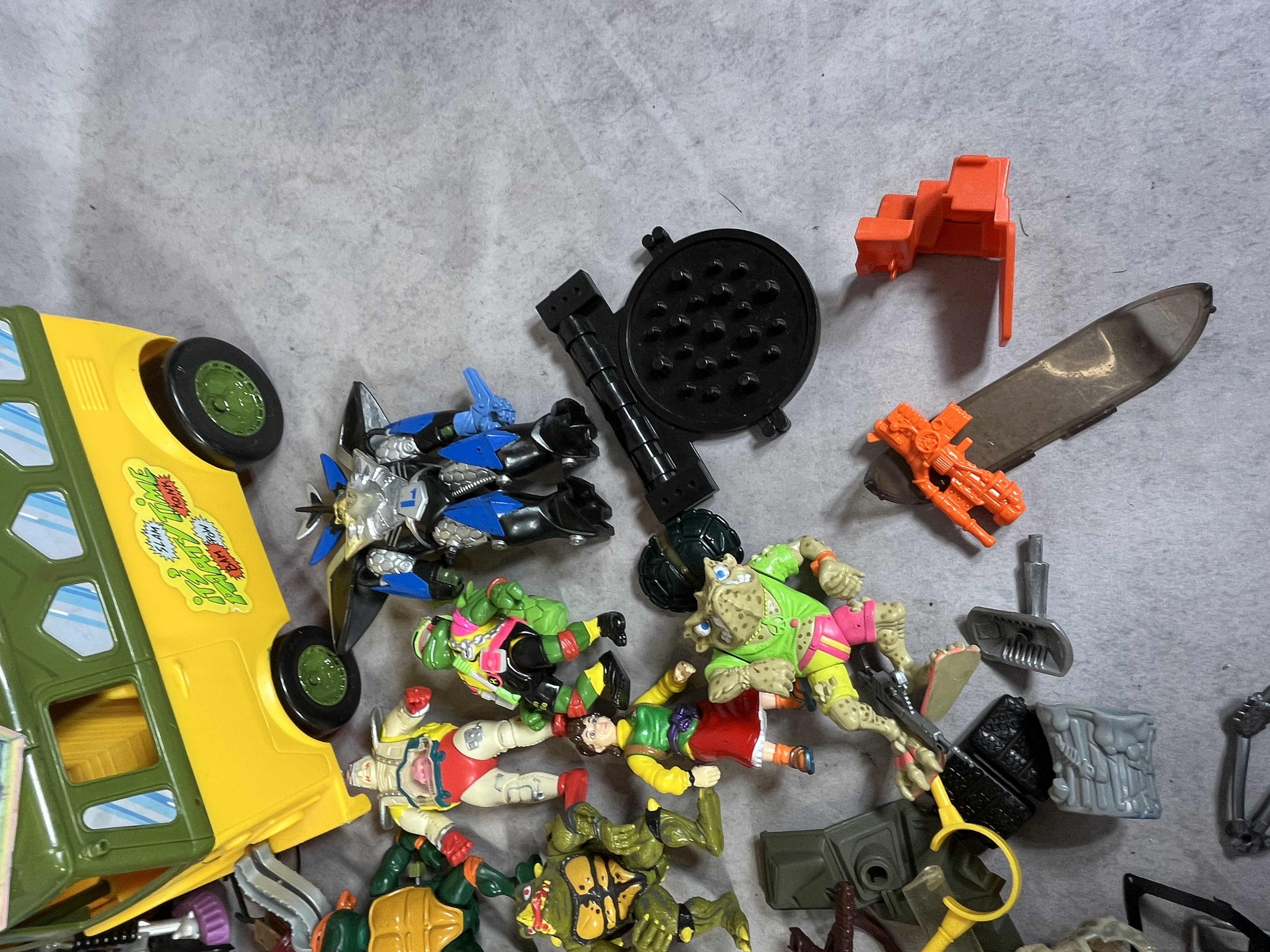 A Collection of Vintage Playmates Teenage Mutant Ninja Turtles Action Figures and Vehicles