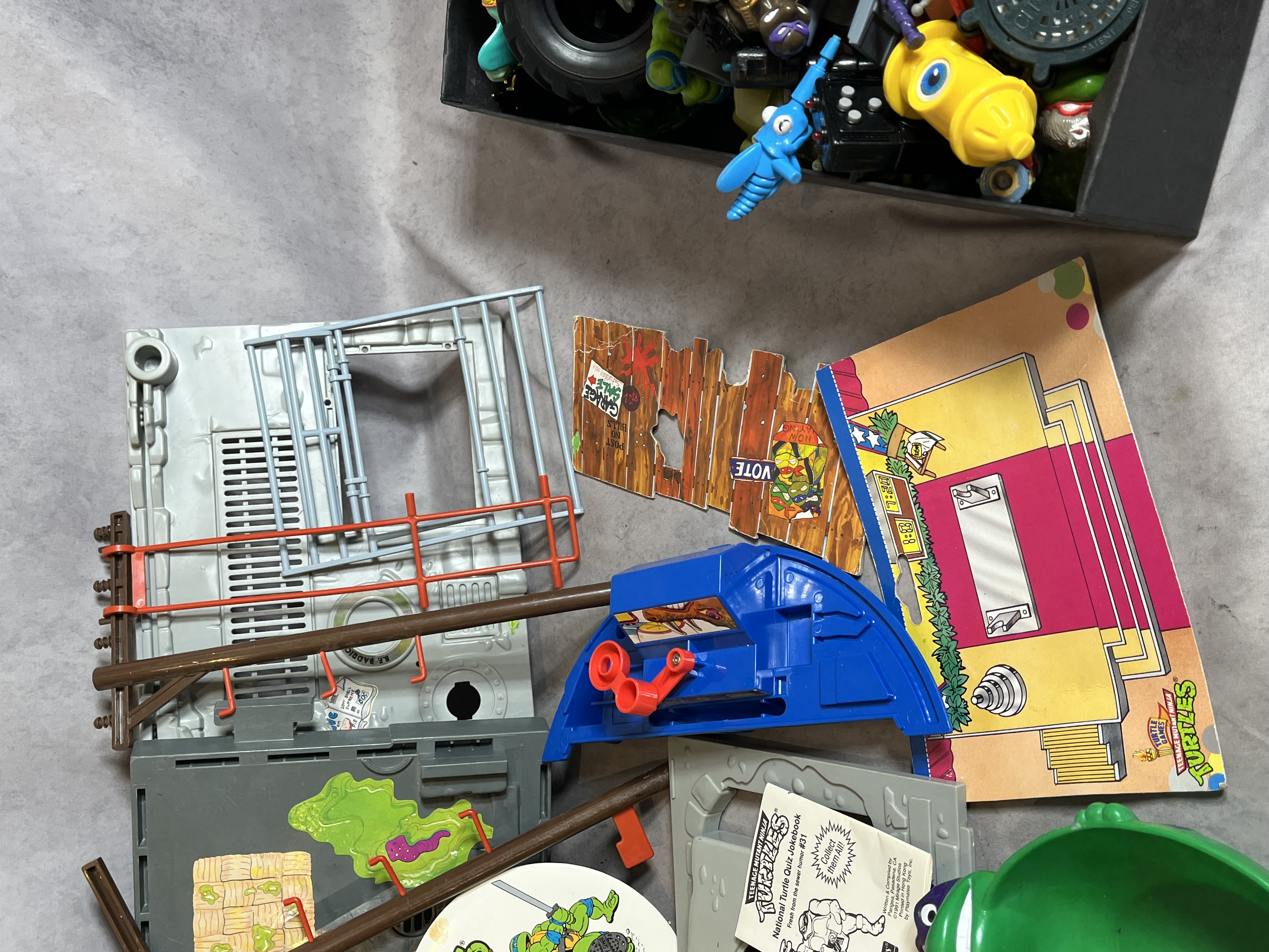 Assortment of Vintage Teenage Mutant Ninja Turtles Action Figures and Sewer Playset Components by Playmates Toys