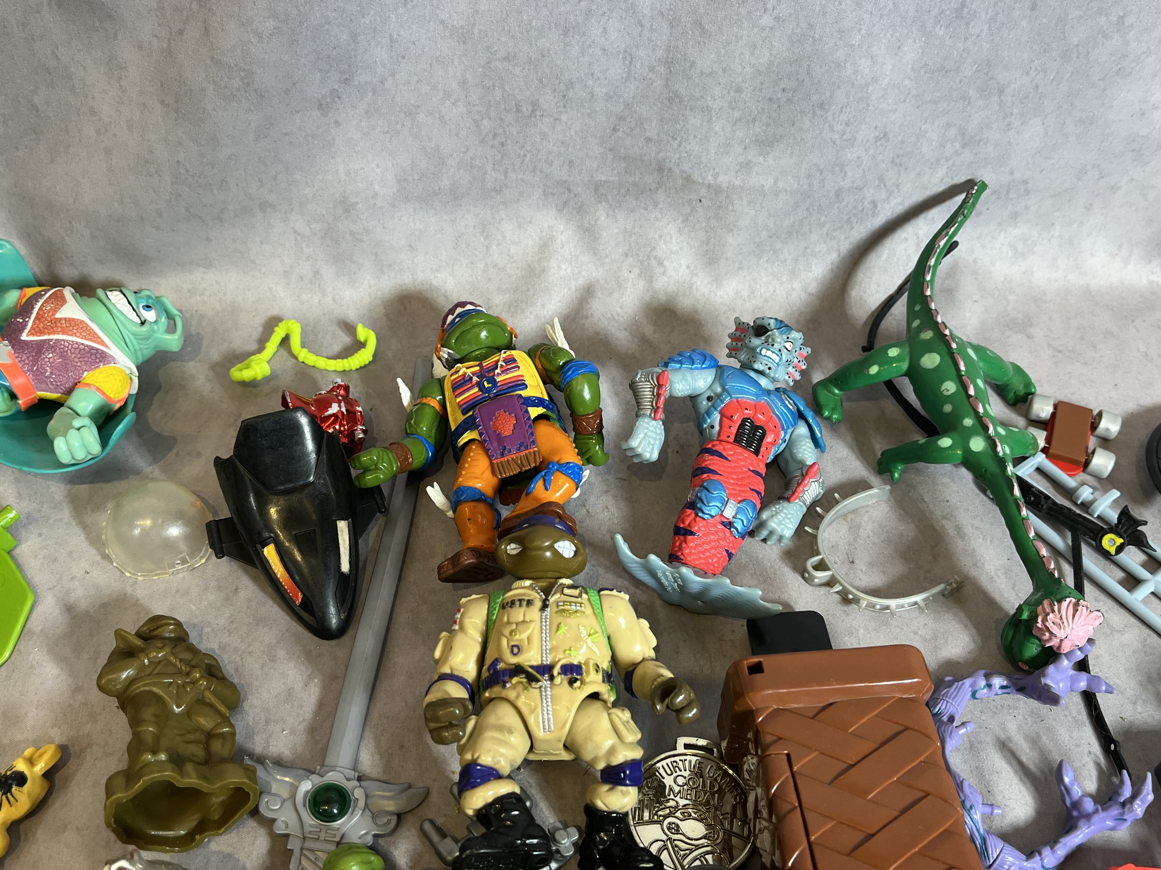 Assortment of Vintage Teenage Mutant Ninja Turtles Action Figures and Sewer Playset Components by Playmates Toys