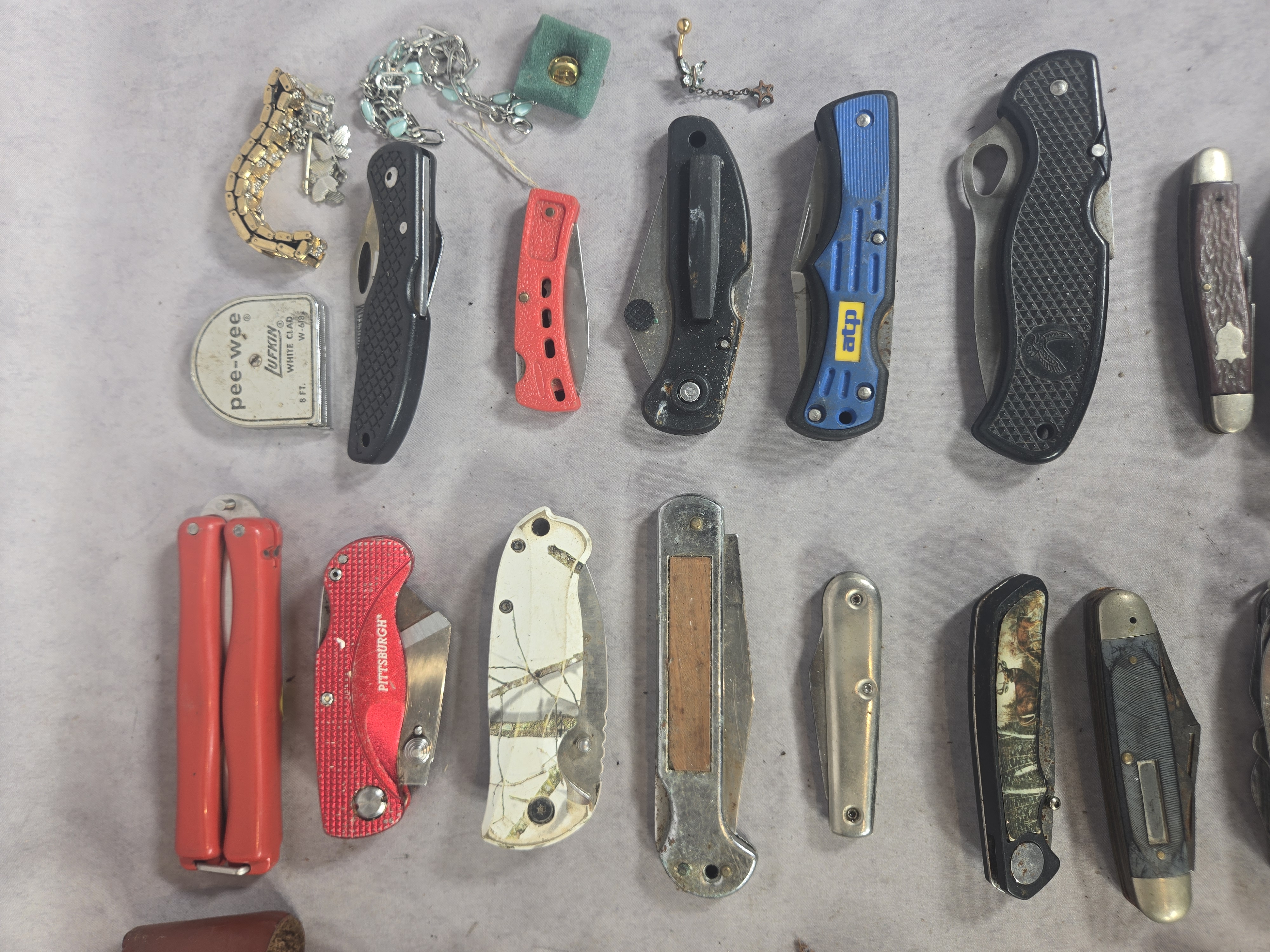 An Assortment of approximately 50 Vintage and Modern Pocket Knives, Multi-tools, and Small Collectibles