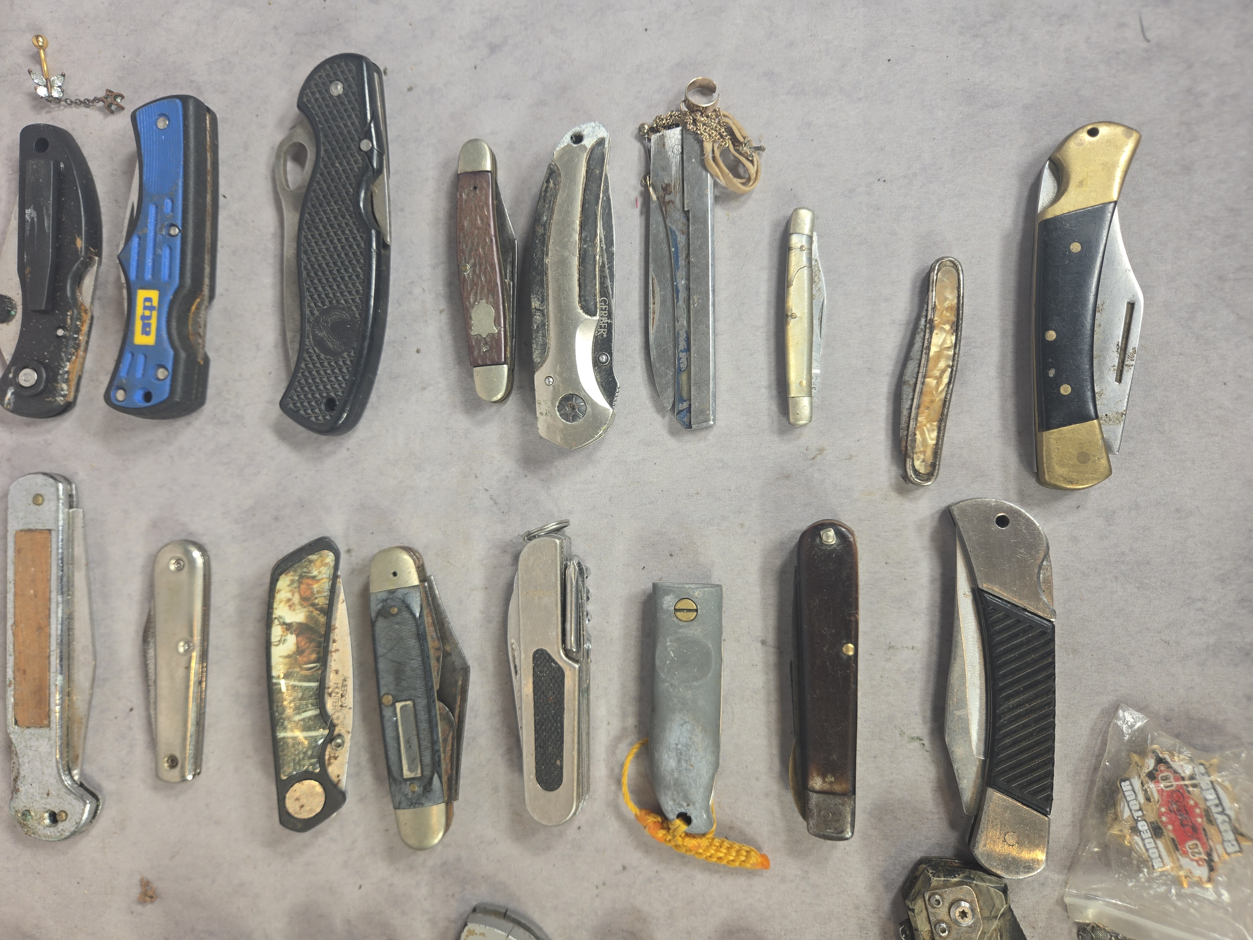 An Assortment of approximately 50 Vintage and Modern Pocket Knives, Multi-tools, and Small Collectibles