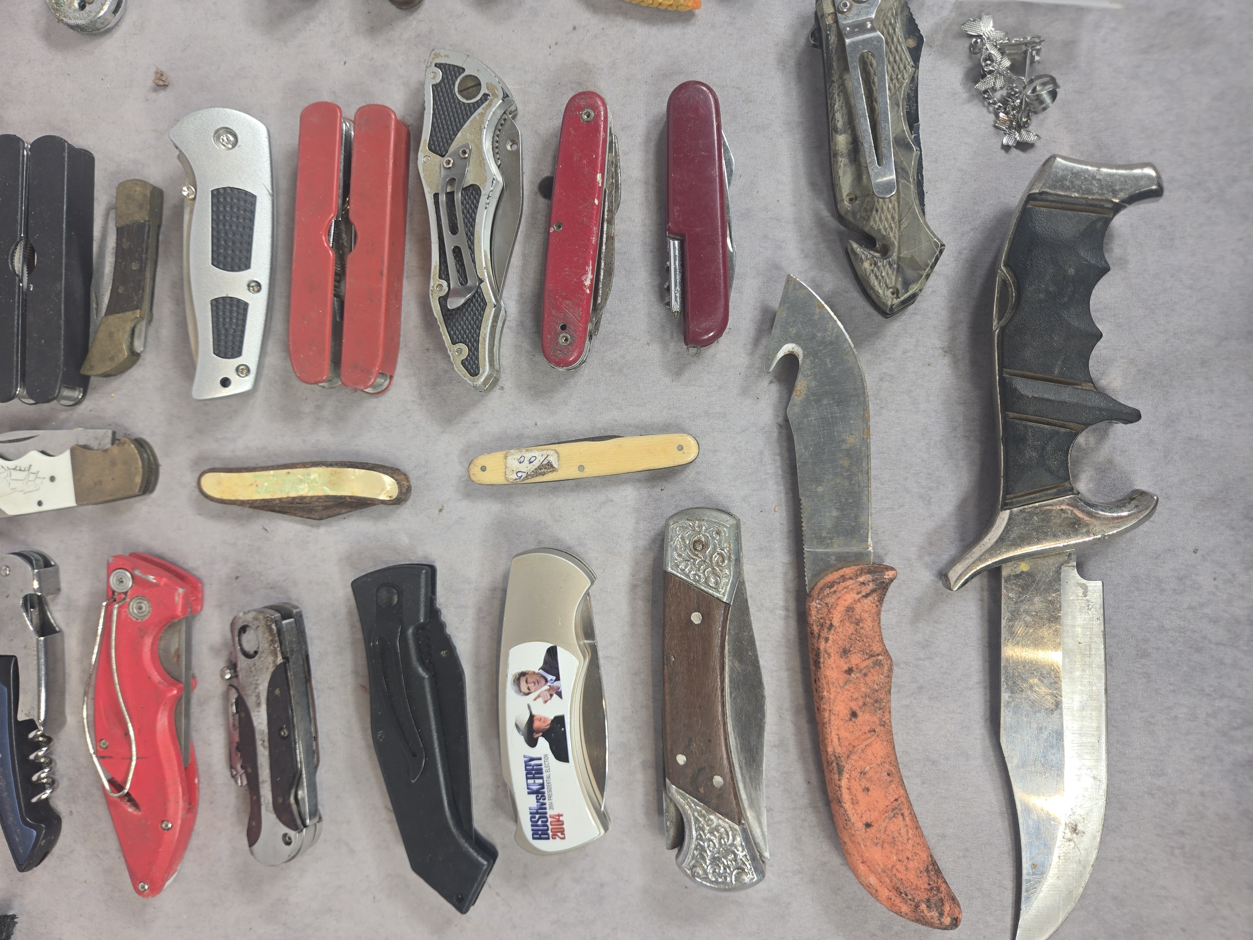 An Assortment of approximately 50 Vintage and Modern Pocket Knives, Multi-tools, and Small Collectibles