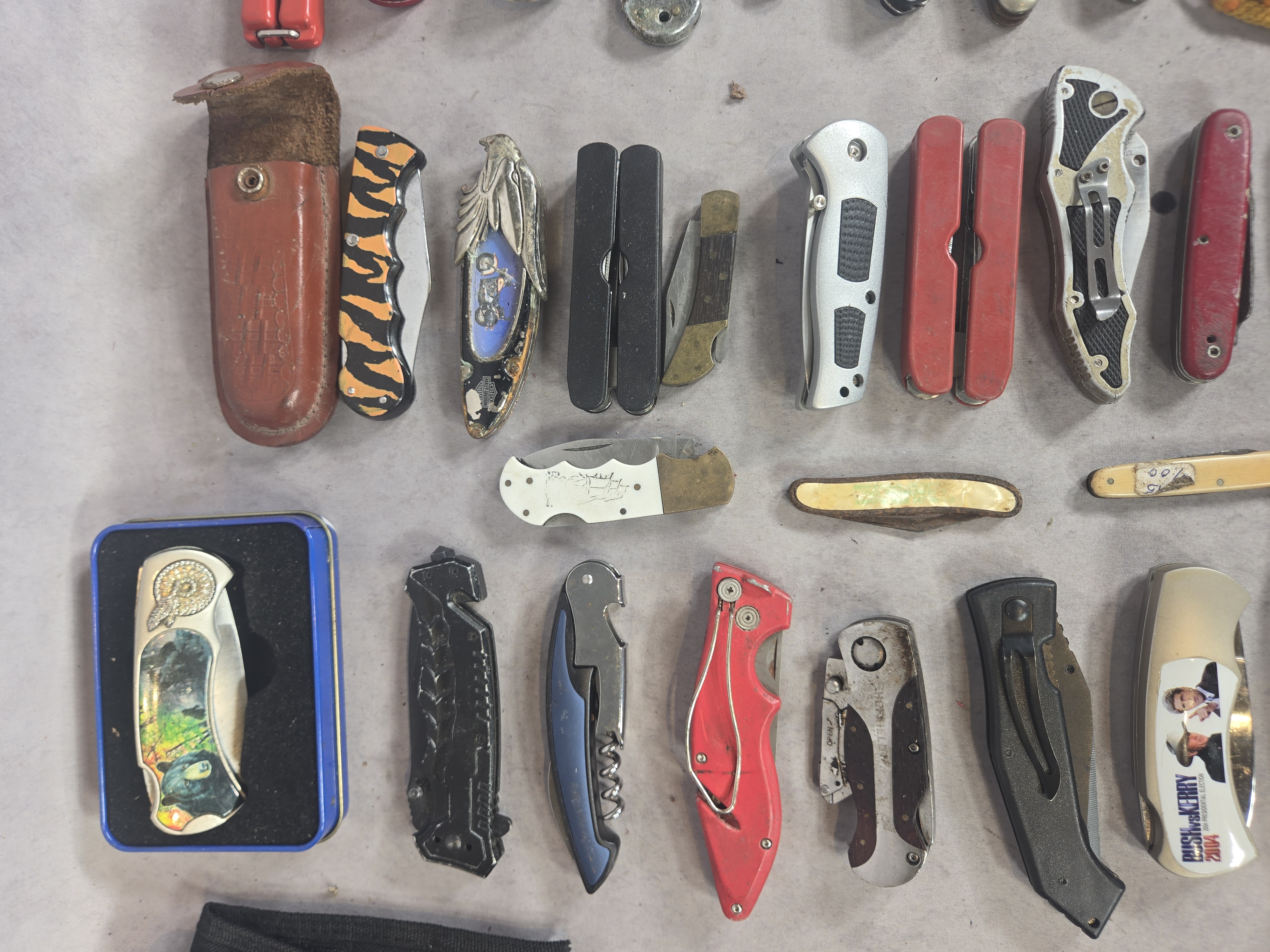An Assortment of approximately 50 Vintage and Modern Pocket Knives, Multi-tools, and Small Collectibles