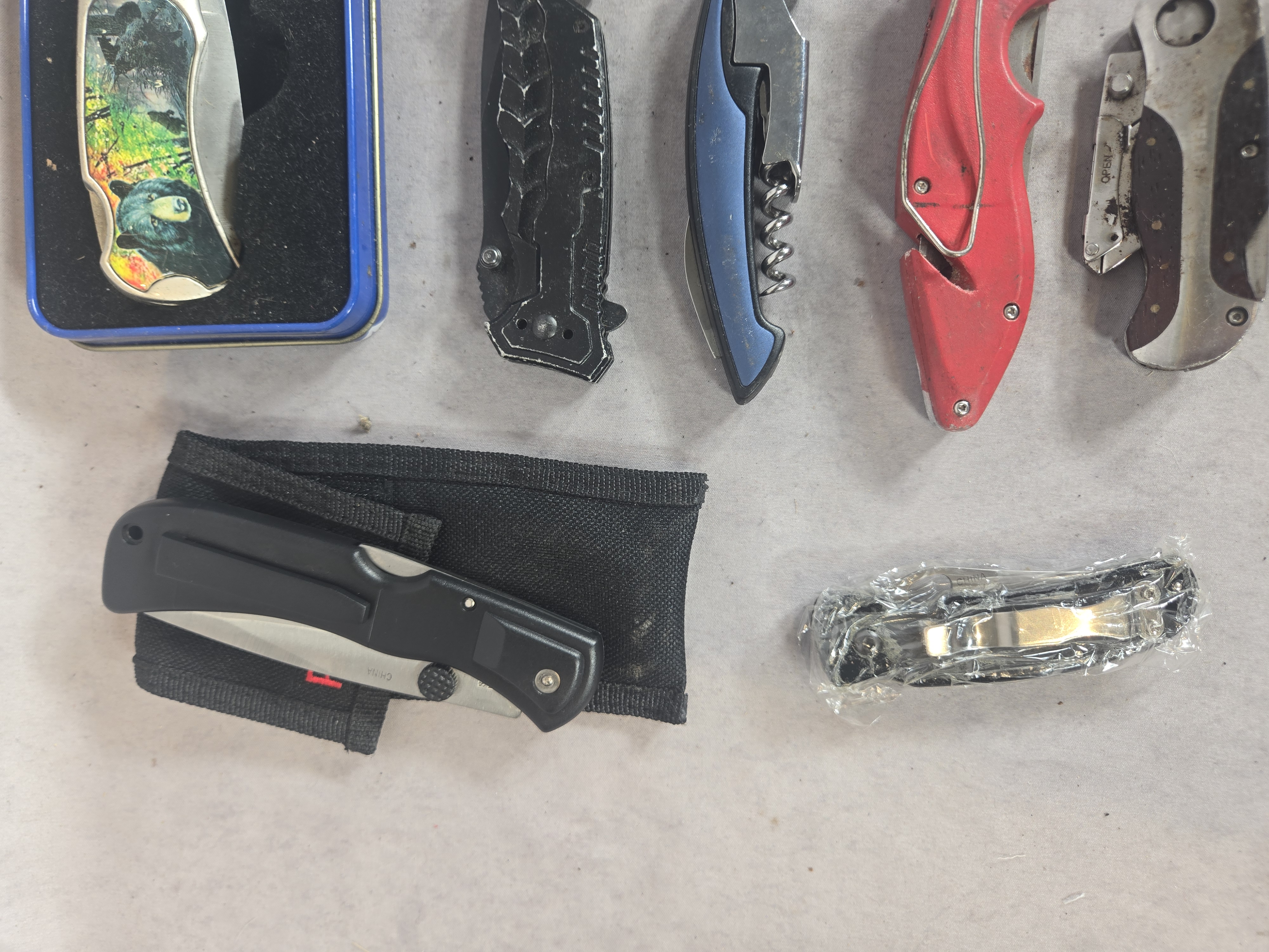 An Assortment of approximately 50 Vintage and Modern Pocket Knives, Multi-tools, and Small Collectibles