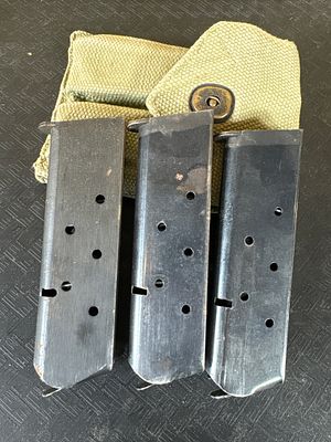 Three M1911 .45 ACP Magazines Including Two Colt-Marked Examples and an M1923 Canvas Pouch. This 