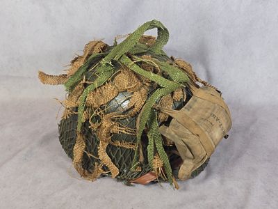 WWII US Army M1C Paratrooper Airborne Helmet with Camouflage Net and First Aid Pouch. A WWII-era 