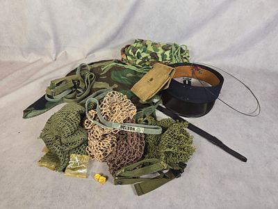 An Assortment of United States Military Headgear Accessories and Equipment. This lot comprises a 