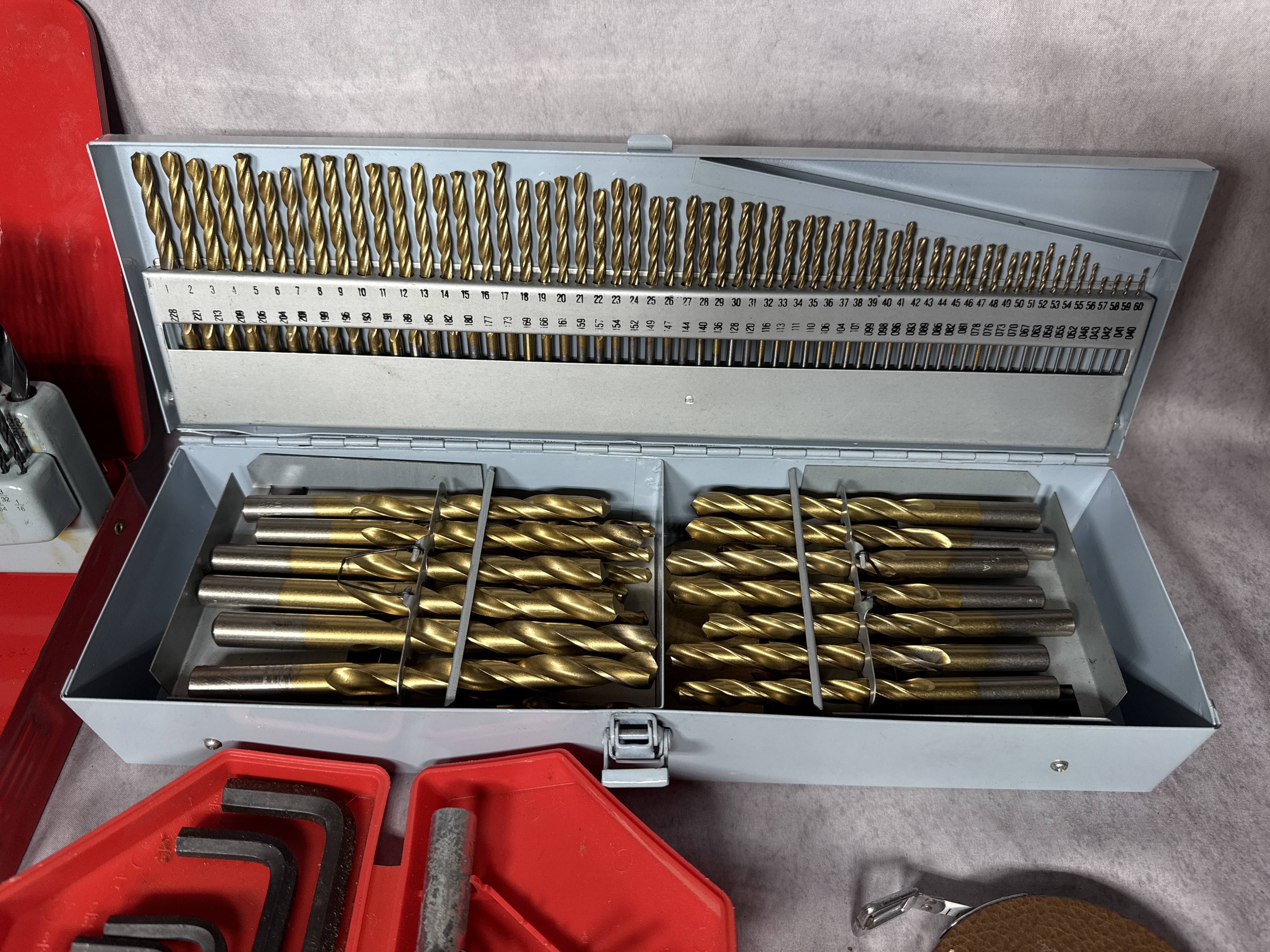 An Assortment of Workshop Hand Tools Including Drill Bit Sets, Hex Keys, and Tape Measures