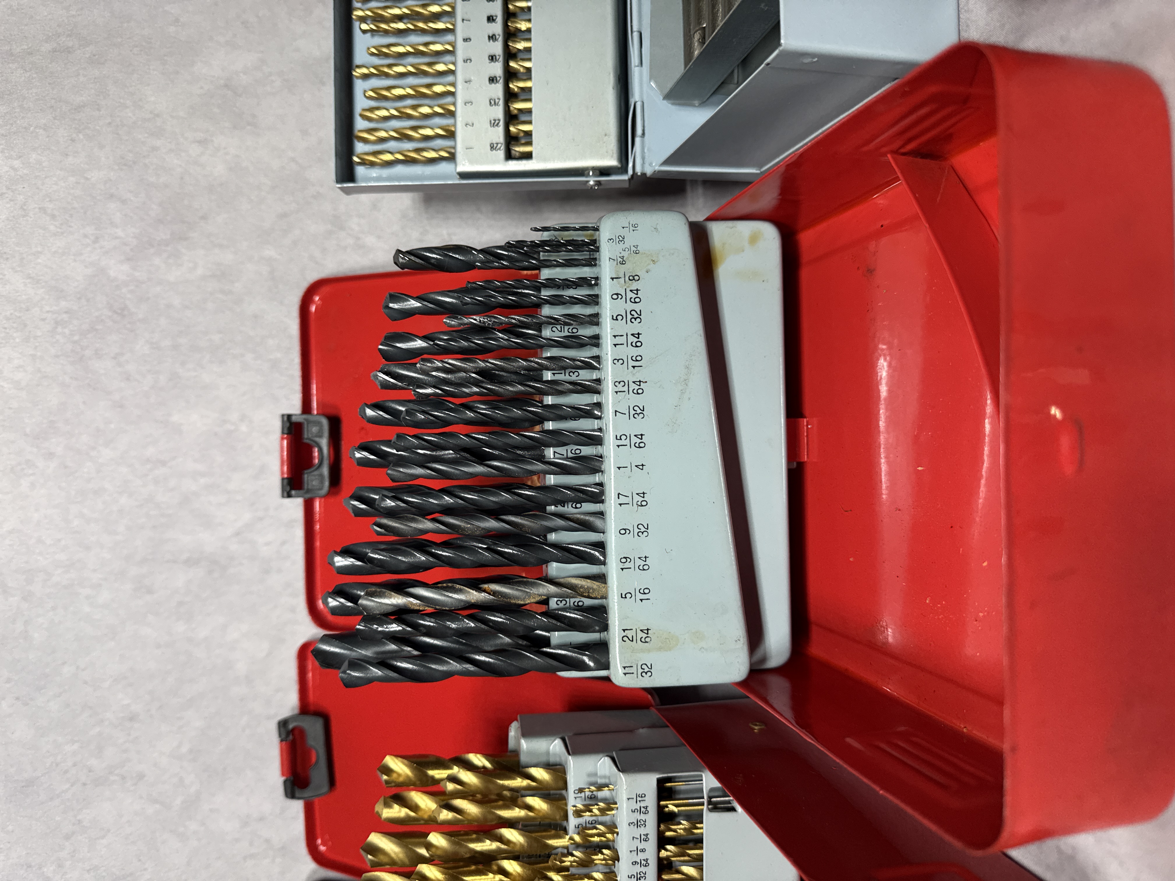 An Assortment of Workshop Hand Tools Including Drill Bit Sets, Hex Keys, and Tape Measures