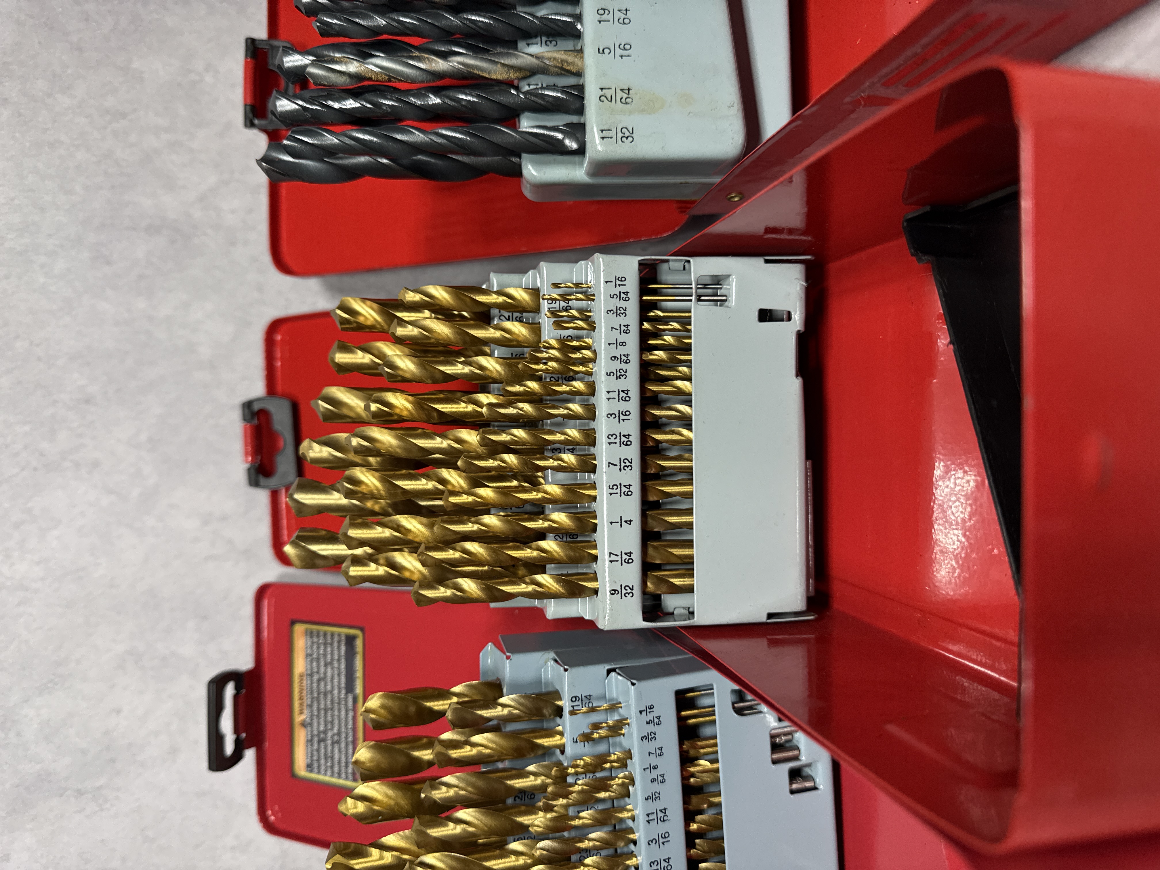 An Assortment of Workshop Hand Tools Including Drill Bit Sets, Hex Keys, and Tape Measures