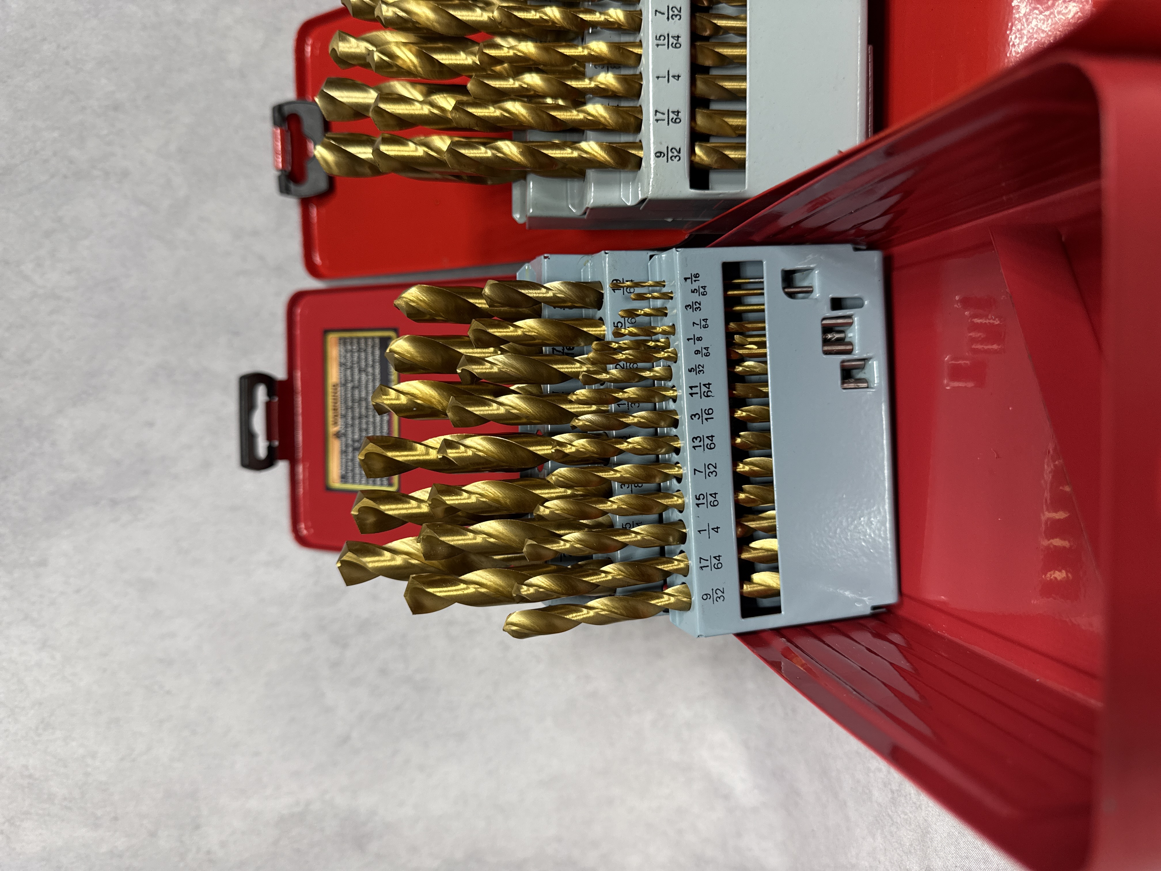 An Assortment of Workshop Hand Tools Including Drill Bit Sets, Hex Keys, and Tape Measures