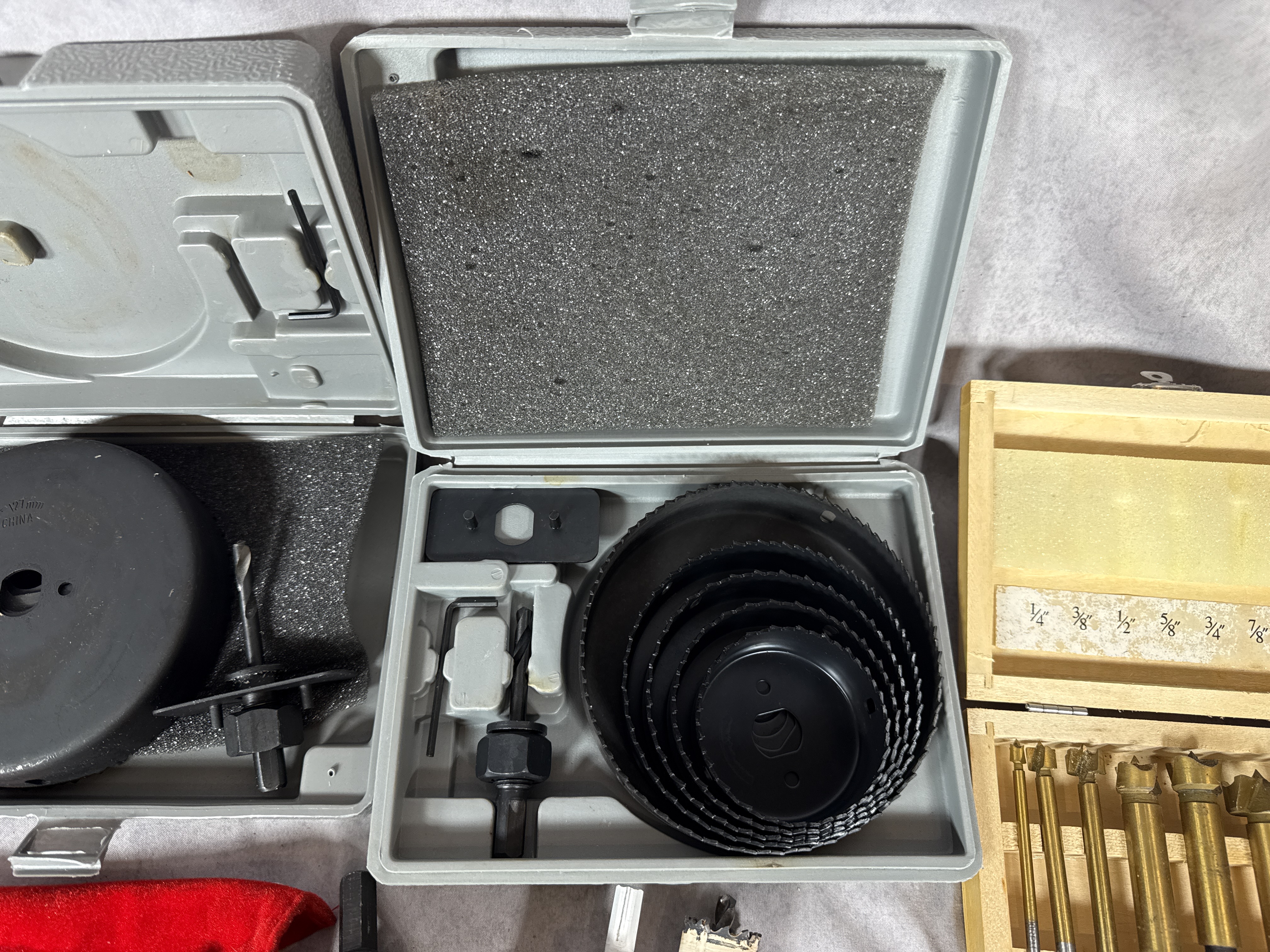 An Assortment of Drilling and Boring Tools Including Hole Saws and Bit Sets