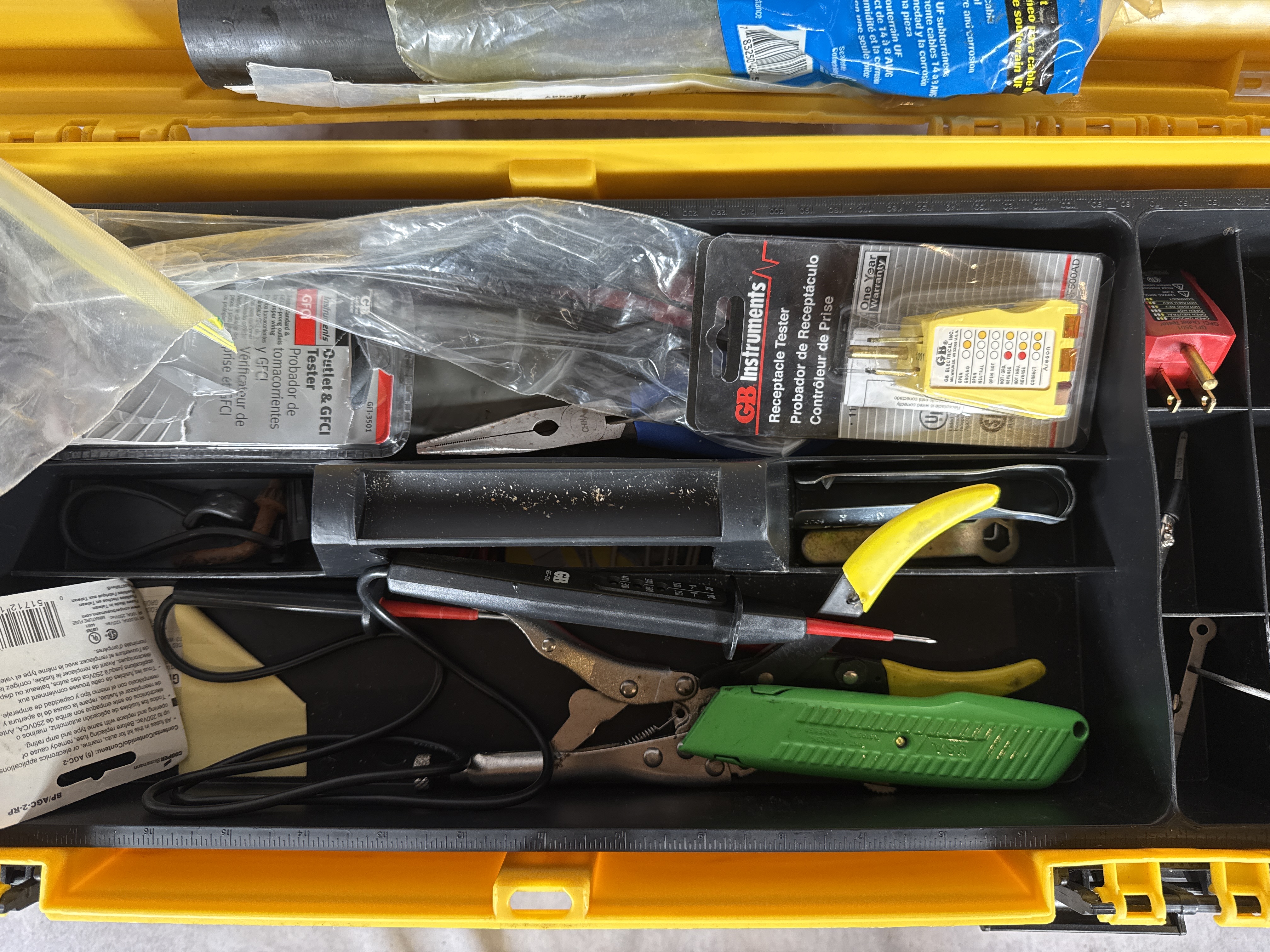 An Assortment of Electrical and Networking Tools and Supplies with a Yellow Plastic Toolbox