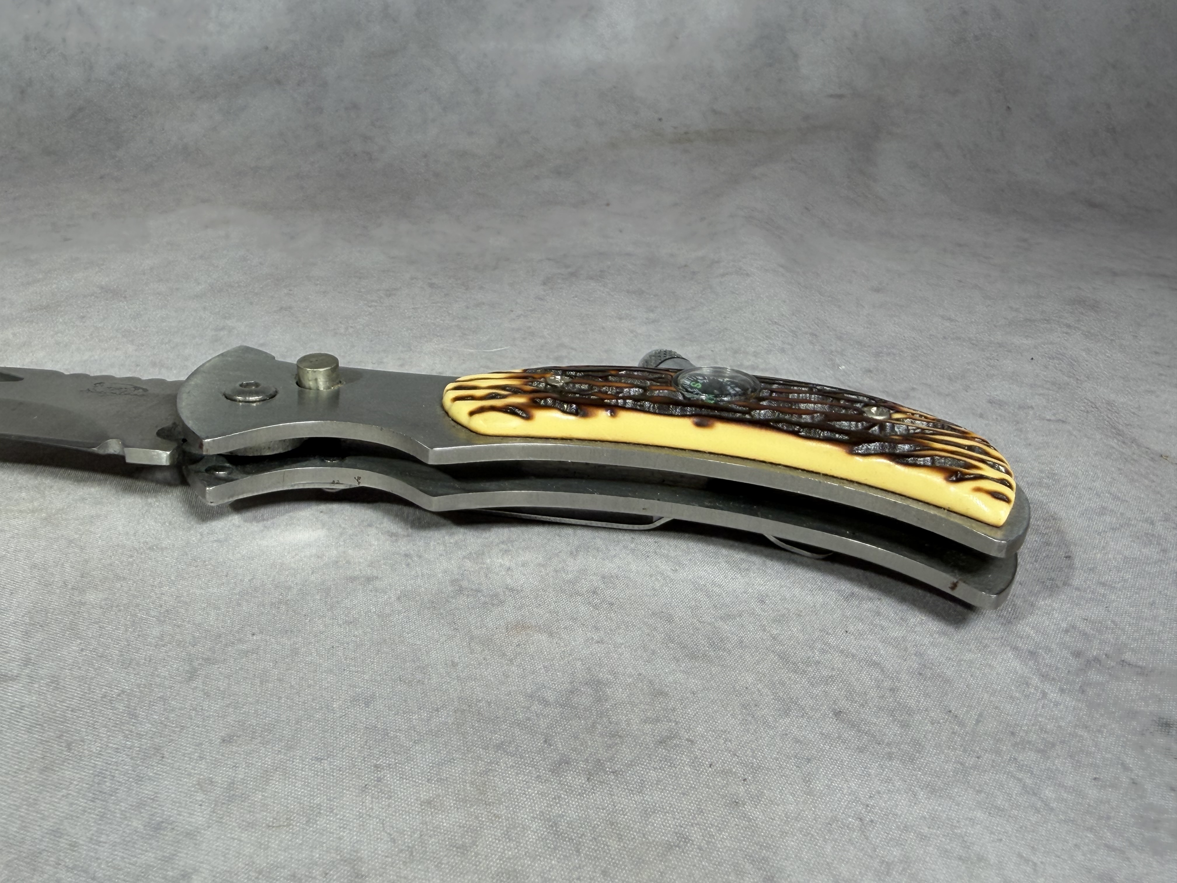 Folding Utility Pocket Knife with Integrated Compass and LED Flashlight