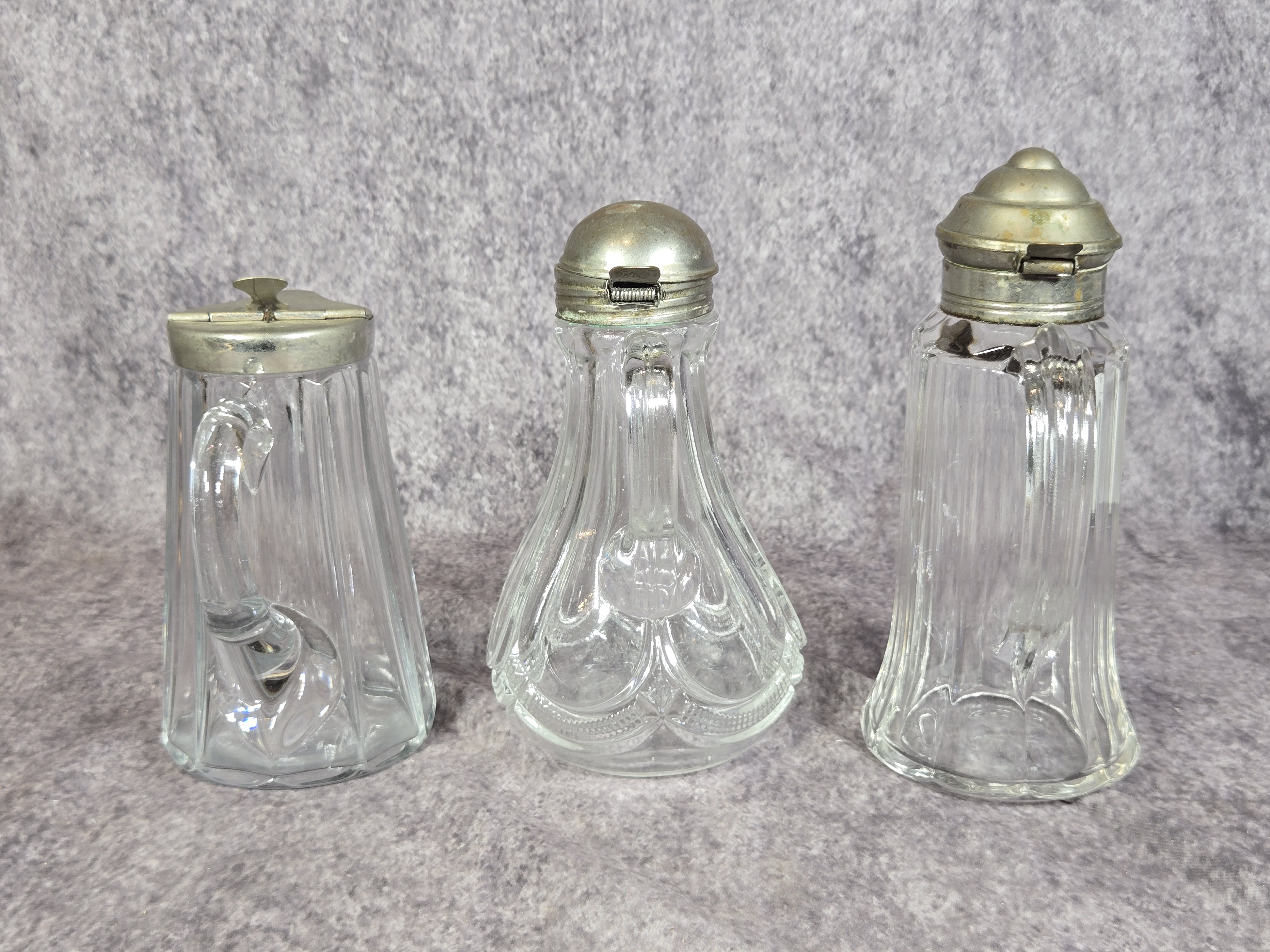 Three Antique Pressed Glass Syrup Pitchers with Metal Lids