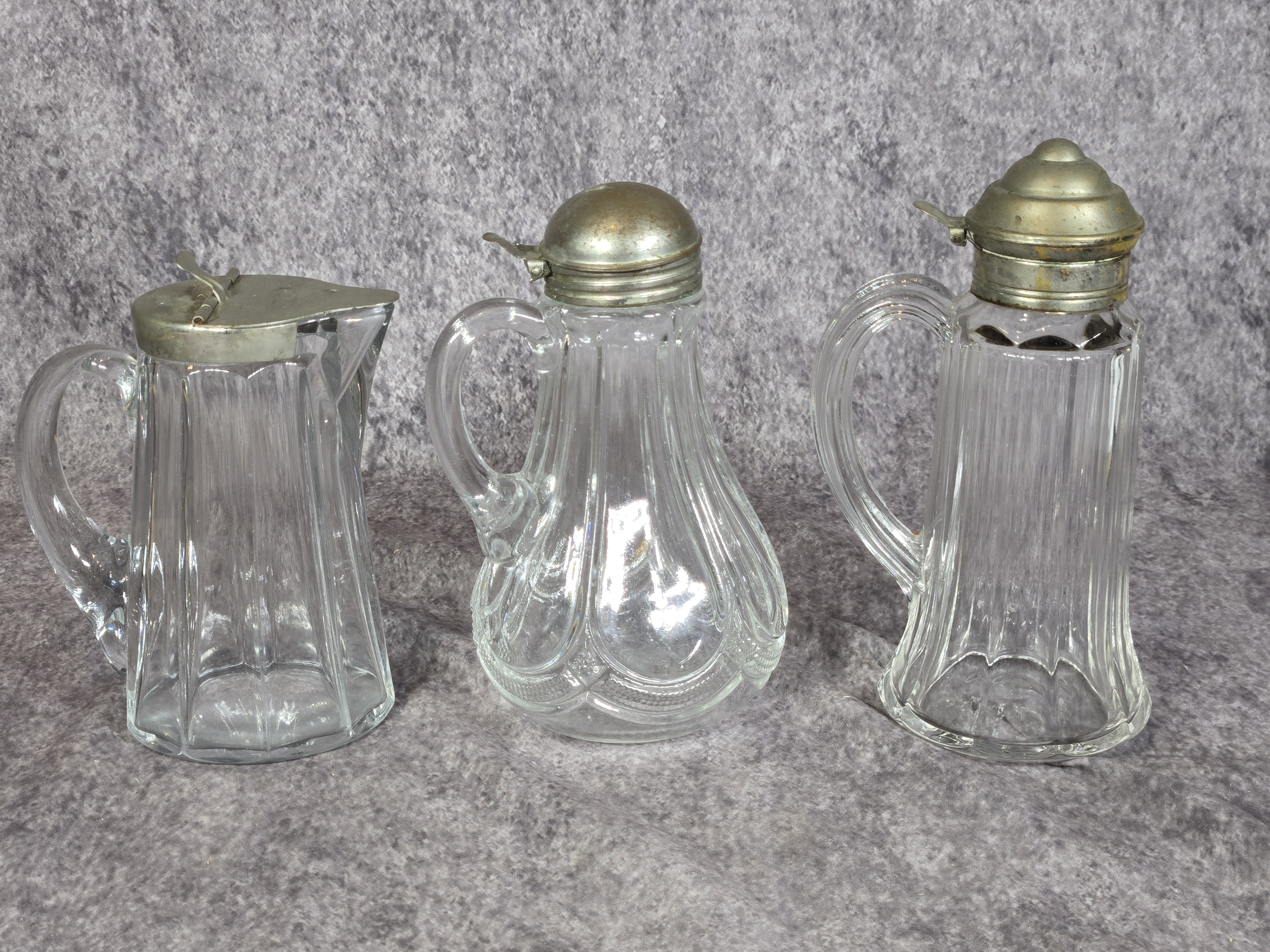 Three Antique Pressed Glass Syrup Pitchers with Metal Lids