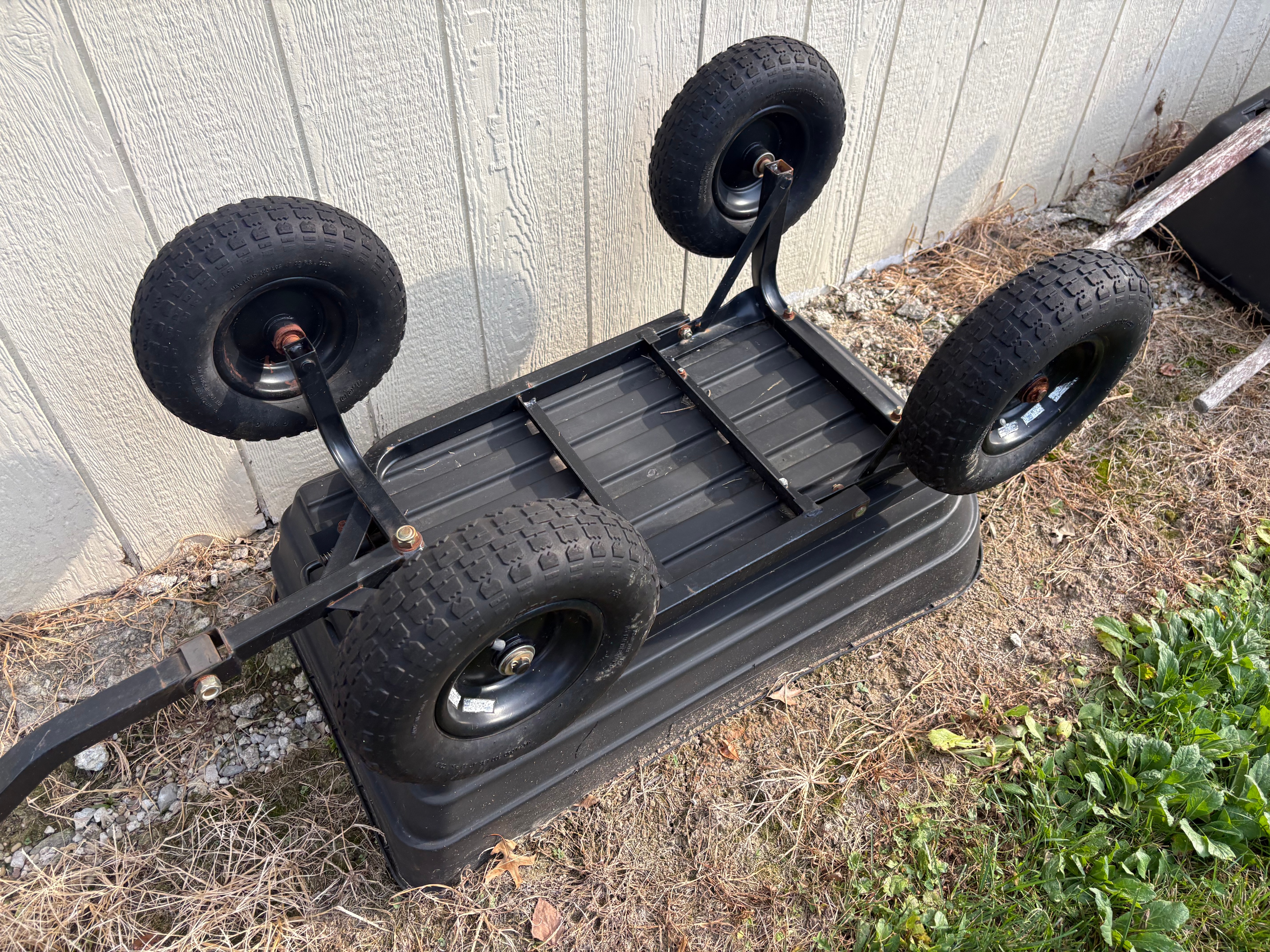 An Assortment of Garden Decor and Utility Equipment including an Ames Wheelbarrow