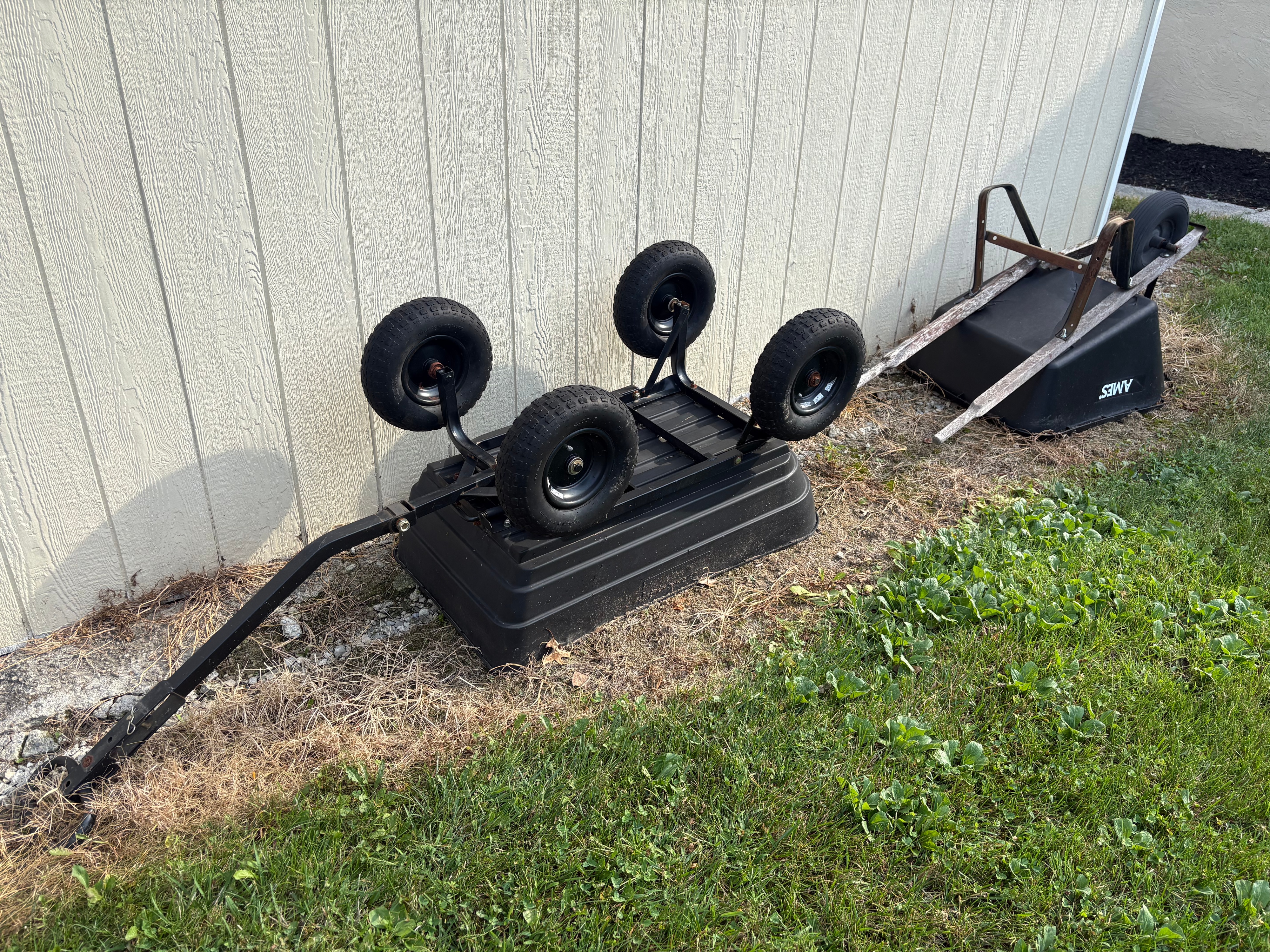 An Assortment of Garden Decor and Utility Equipment including an Ames Wheelbarrow