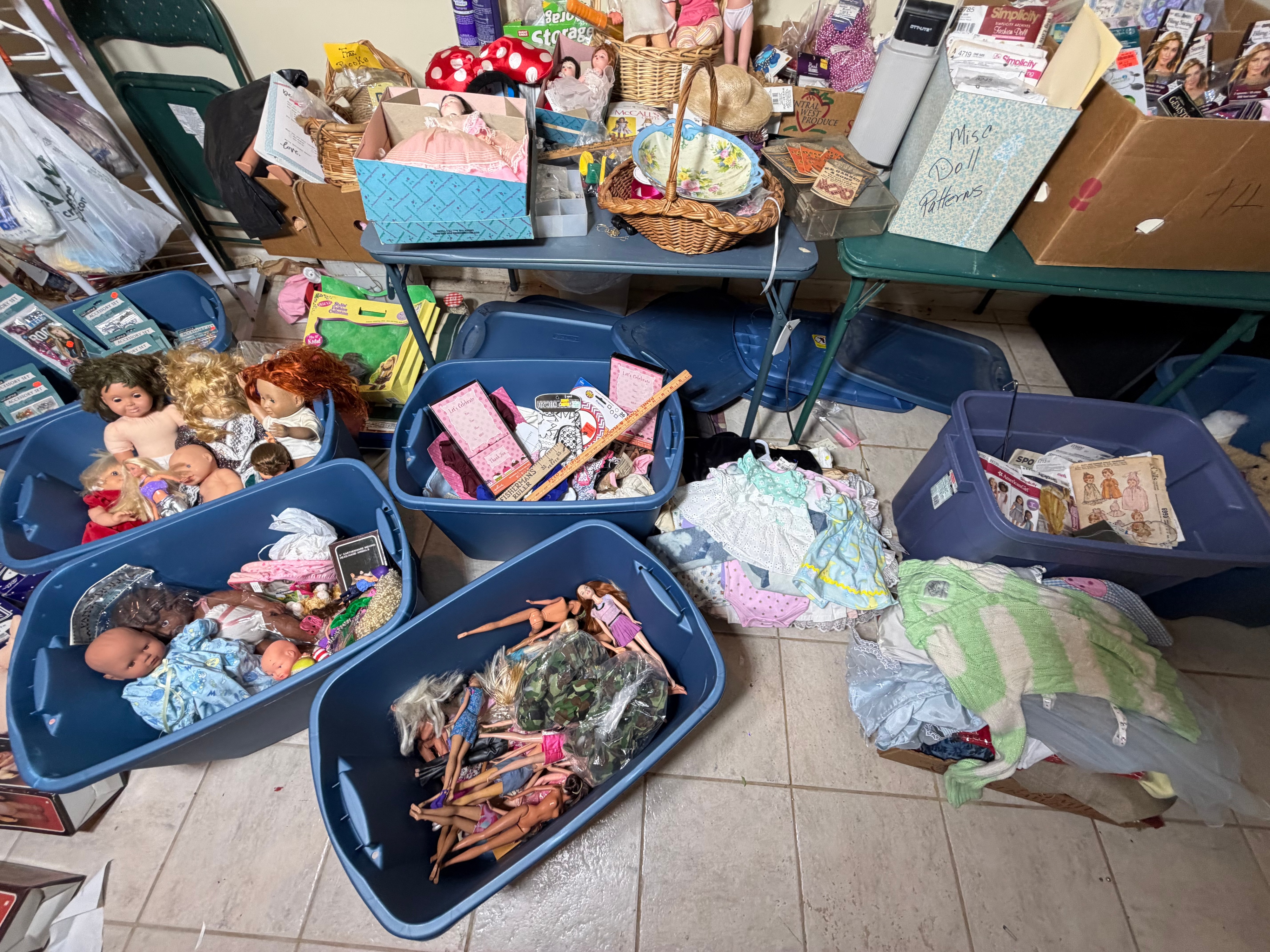 CONTENTS LOT: A Large Collection of Cabbage Patch Kids, American Girl, and Barbie Dolls with Sewing Patterns, Craft Kits, and Trims