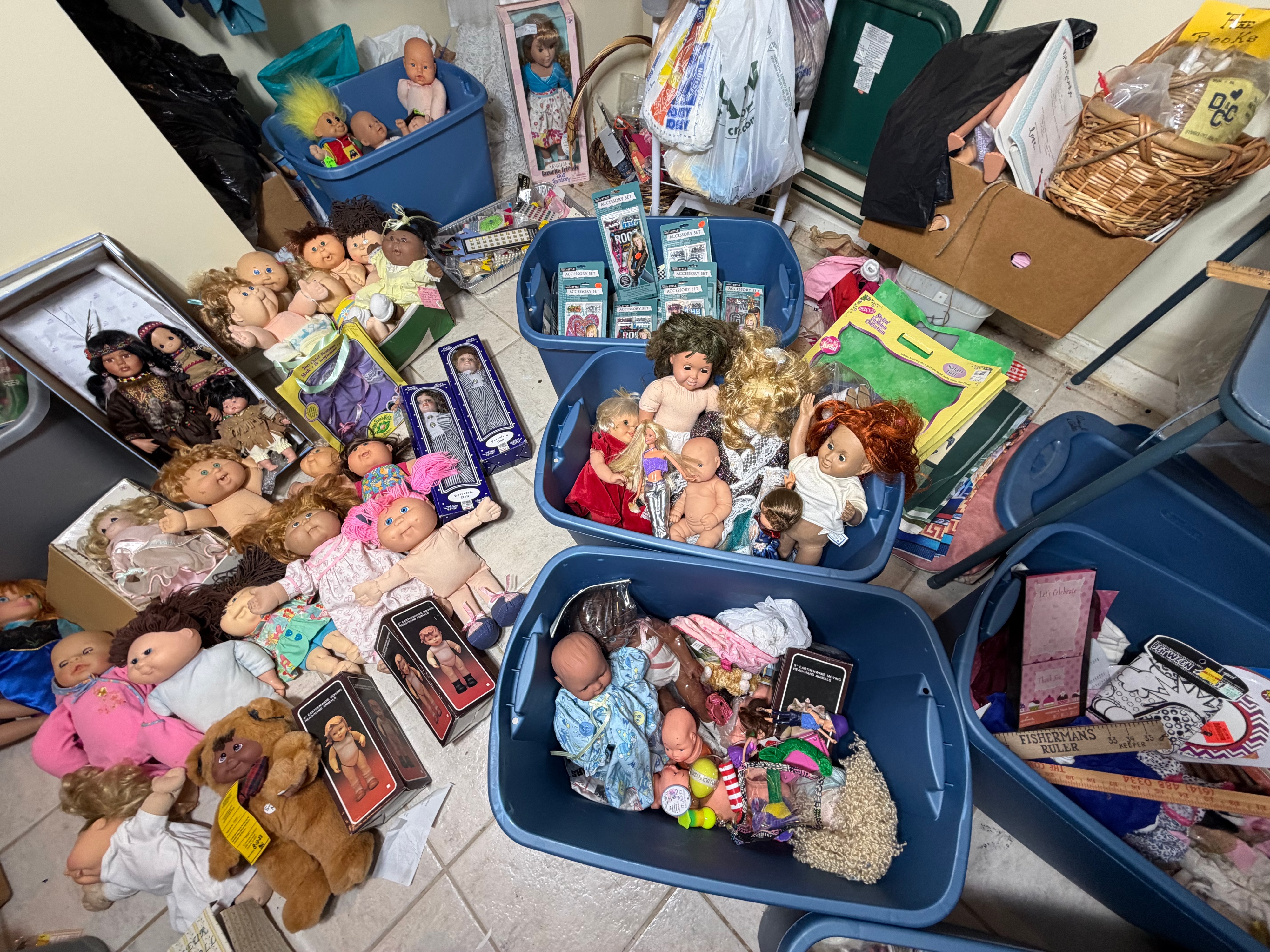 CONTENTS LOT: A Large Collection of Cabbage Patch Kids, American Girl, and Barbie Dolls with Sewing Patterns, Craft Kits, and Trims