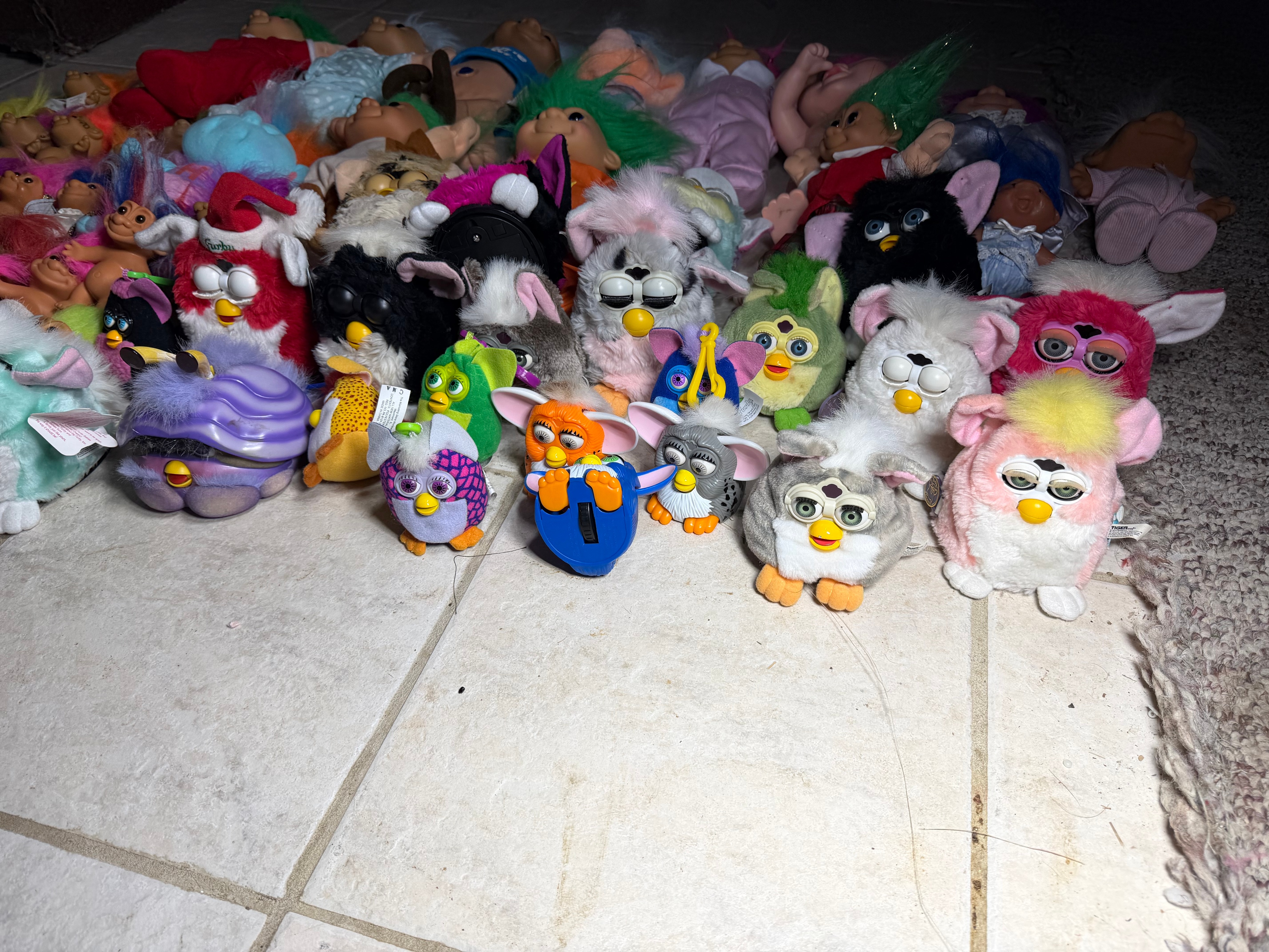 A Collection of Vintage 1990s Tiger Electronics Furby Toys and Assorted Troll Dolls