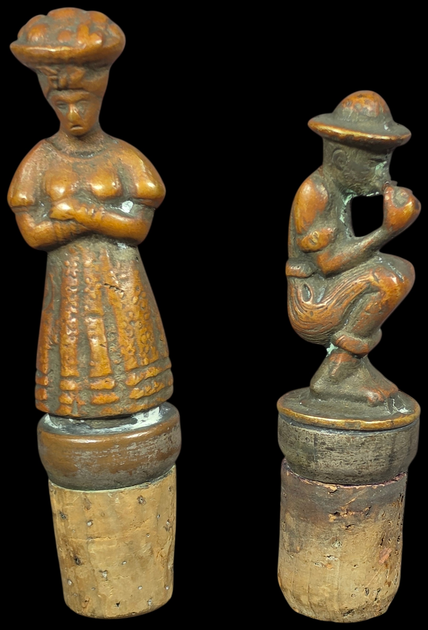A Pair of Cast Bronze Figural Bottle Stoppers