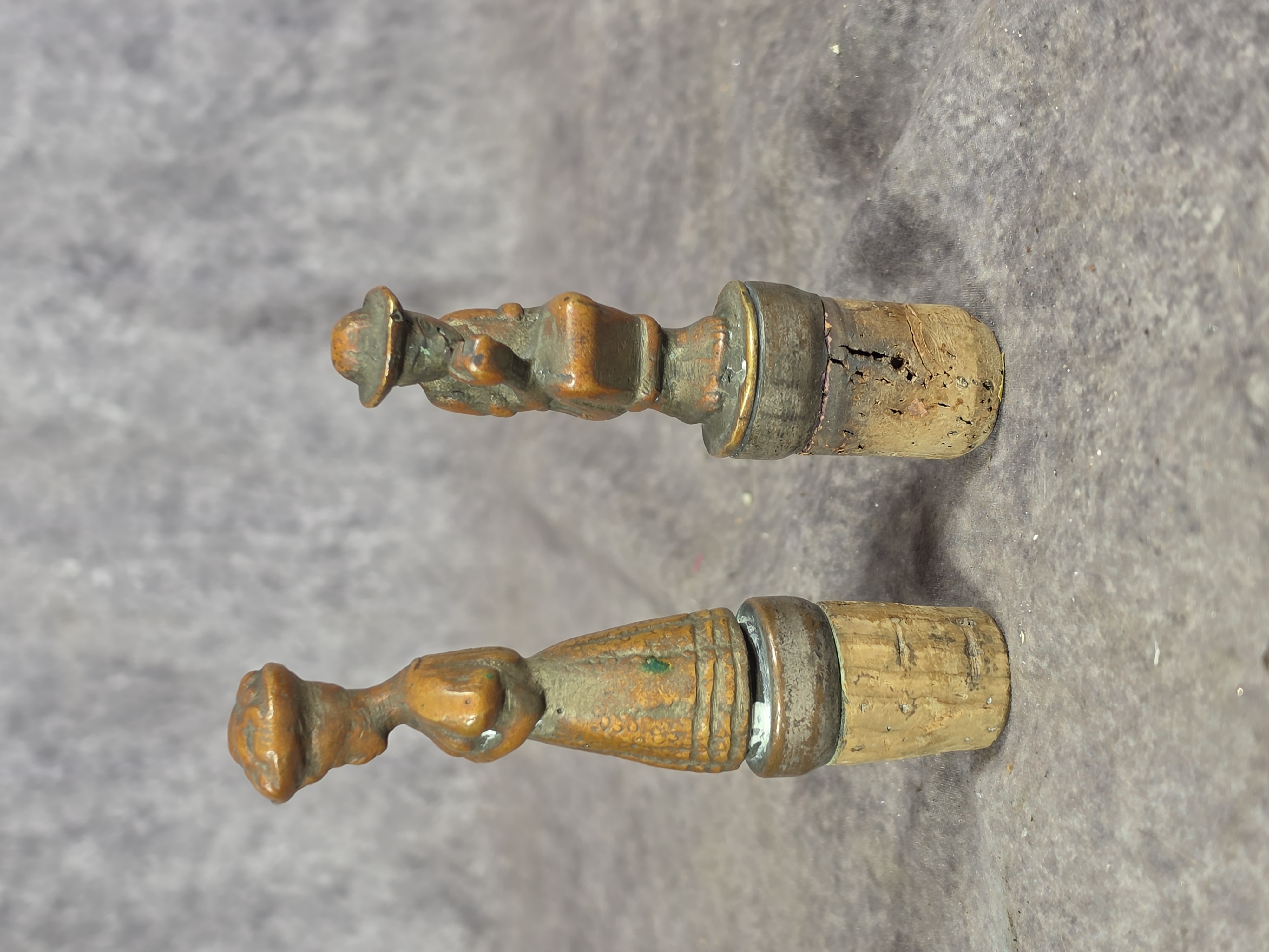 A Pair of Cast Bronze Figural Bottle Stoppers
