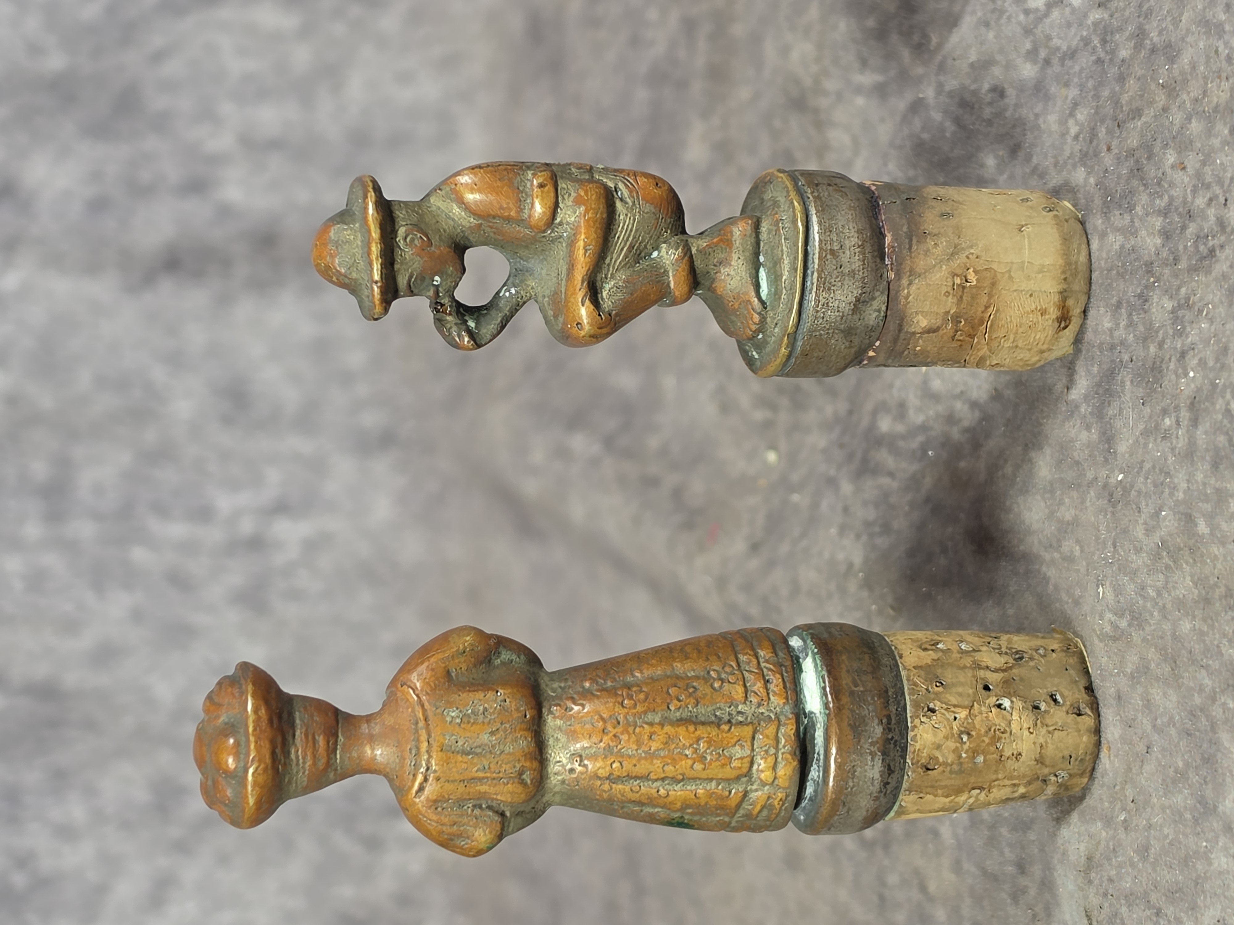 A Pair of Cast Bronze Figural Bottle Stoppers