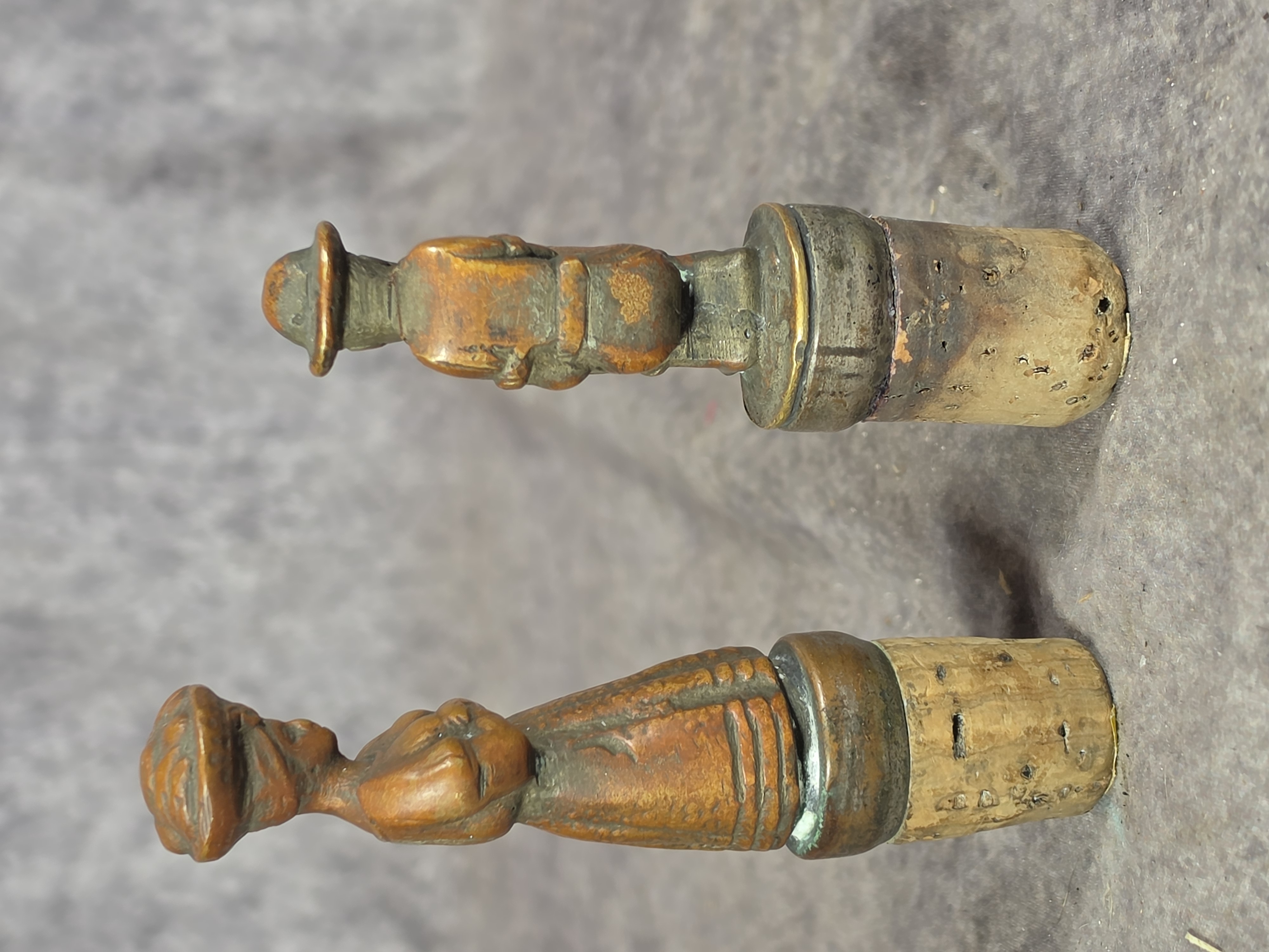 A Pair of Cast Bronze Figural Bottle Stoppers