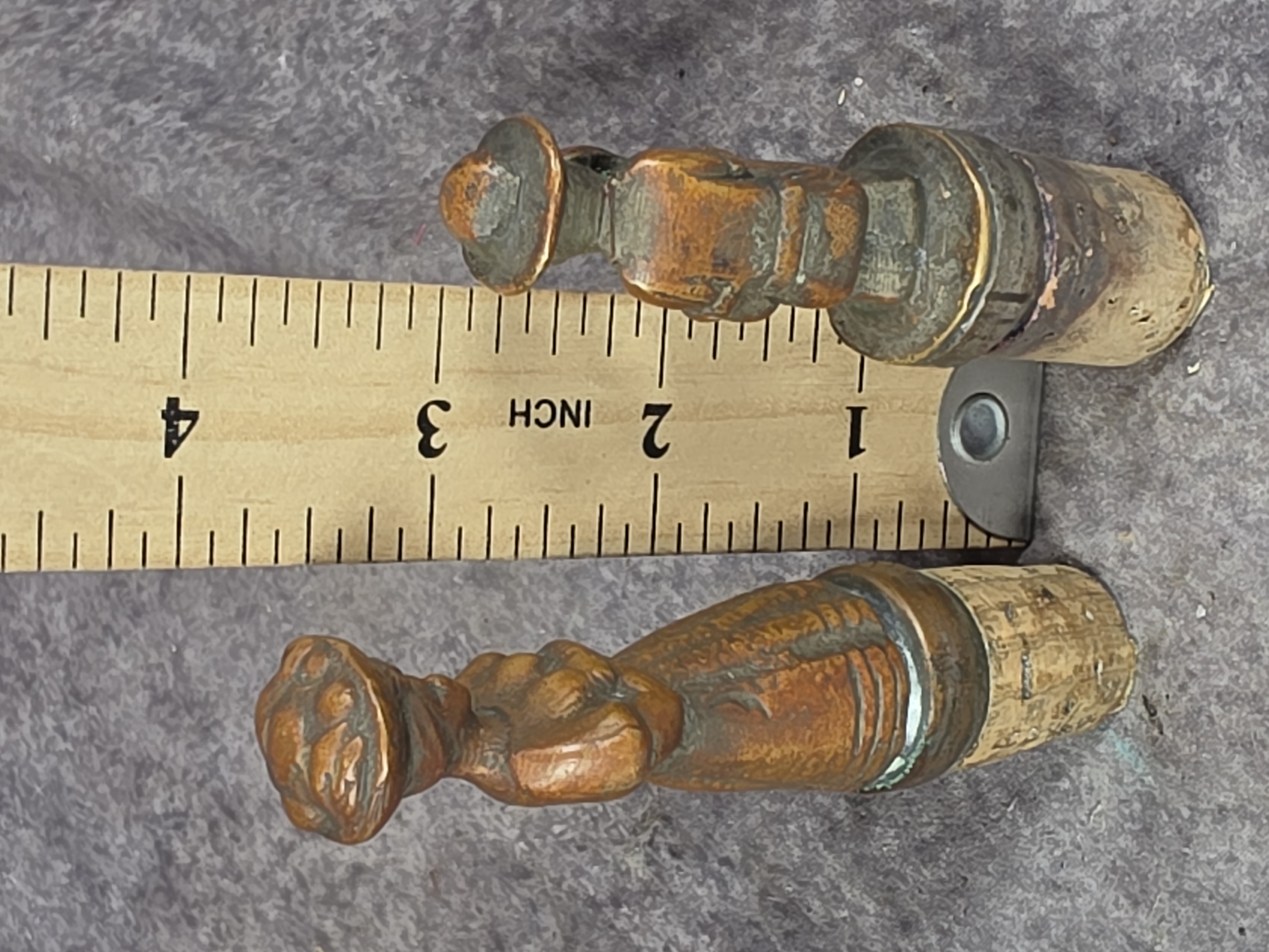 A Pair of Cast Bronze Figural Bottle Stoppers