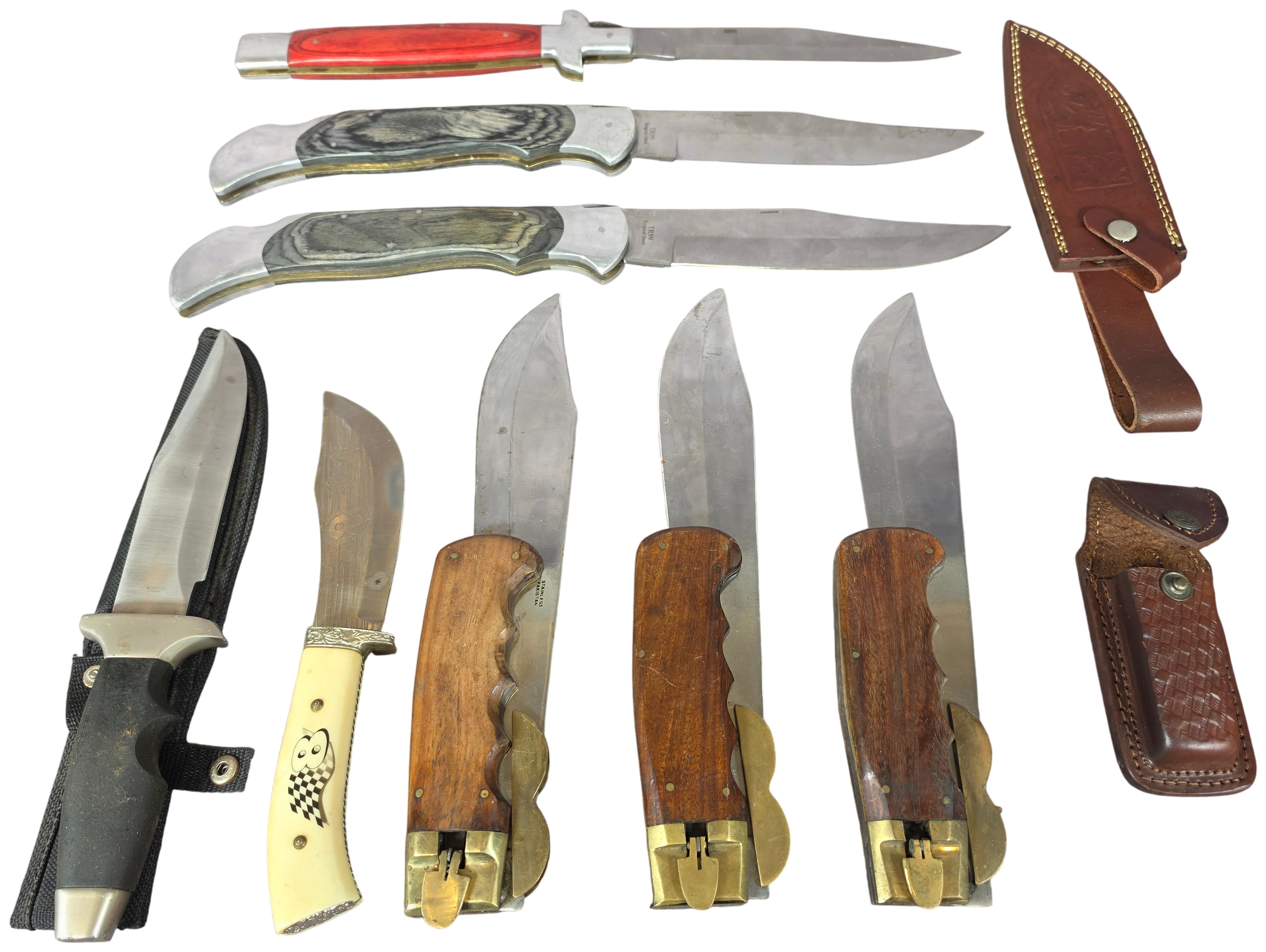 A Collection of Eight Oversized Folding and Fixed Blade Knives from Pakistan and China