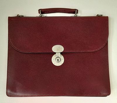 A Flap Over Document Case in maroon tooled leather by Simpson of London. 41cm x 33cm. Unused 
