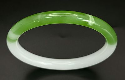 A Green and White Thin Jade Chinese Bangle. 7mm width. 6cm inner diameter.