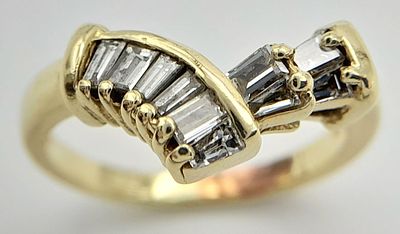 A 14K Yellow Gold Tapered Baguette Diamond Ring. Chevron form with ten tapered diamonds. Size 