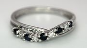 A 9K WHITE GOLD DIAMOND AND SAPPHIRE CROSSOVER RING. 1.5G. SIZE N. SC - 1030.Image - 1