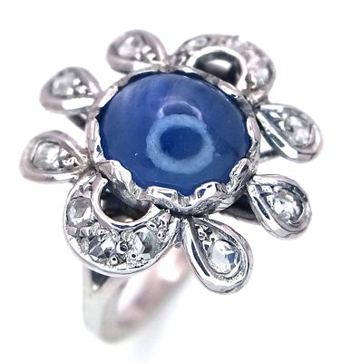 A 18K white gold diamond and sapphire fancy ring, 0.20ct diamond weight, 9x7mm cabochon