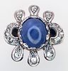A 18K white gold diamond and sapphire fancy ring, 0.20ct diamond weight, 9x7mm cabochon Image - 1