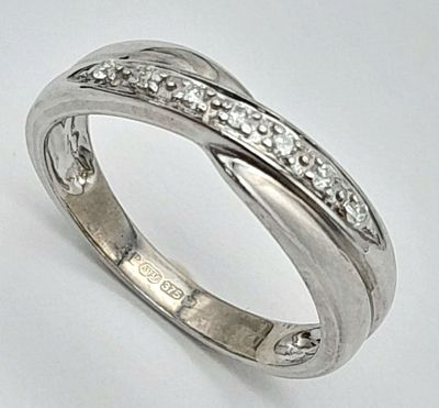 A 9K WHITE GOLD DIAMOND SET CROSSOVER RING. 2.4G. SIZE L. SC - 1017.