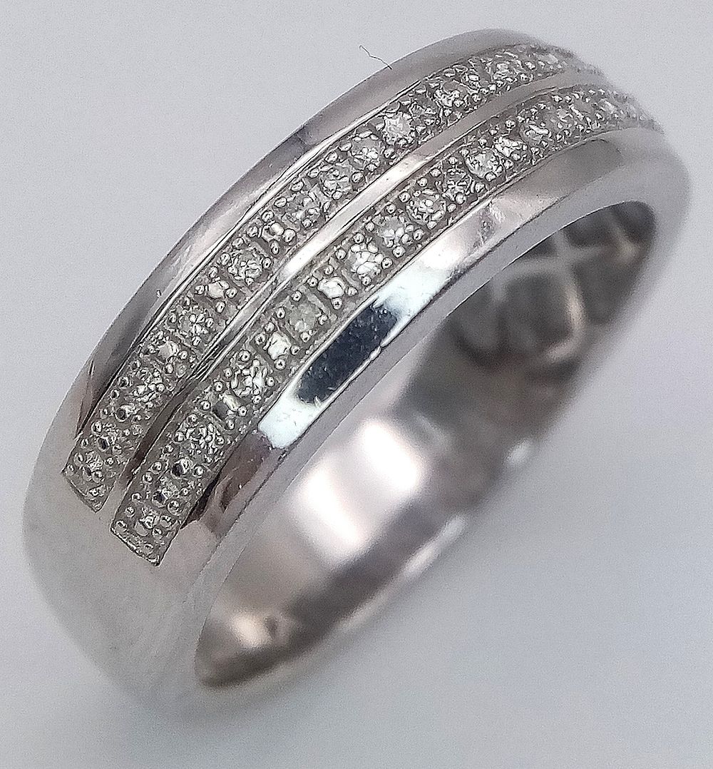 A 9K white gold diamond double row ring, 0.18ct diamond weight, 5.9g total weight, ring size S. 