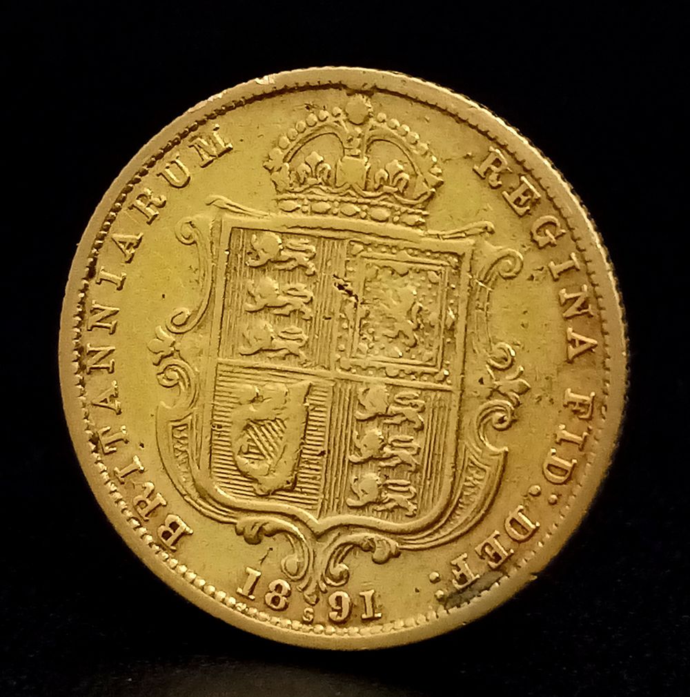 An 1891 Queen Victoria Half Sovereign 22k Gold Coin. Sydney mint, shield back. No initials. C-1003.