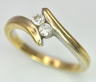 An 18k yellow gold diamond crossover ring, 0.10ct diamond weight, 3.3g total weight, size K1/2.