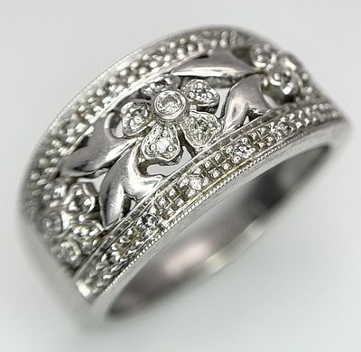 A 9k white gold, decorative diamond floral ring, 7g total weight, 0.09ct diamond weight, size