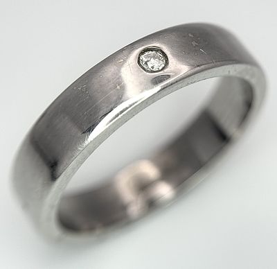A 9k white gold diamond wedding band. 7.3g total weight, size U. CW01.
