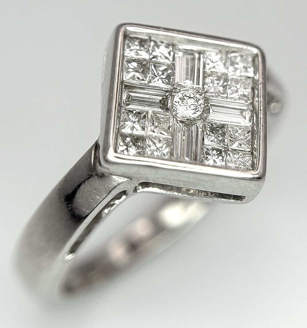 An 18K White Gold Diamond Ring. Princess and baguette cut diamonds - 0.47ctw, 4g total weight. 